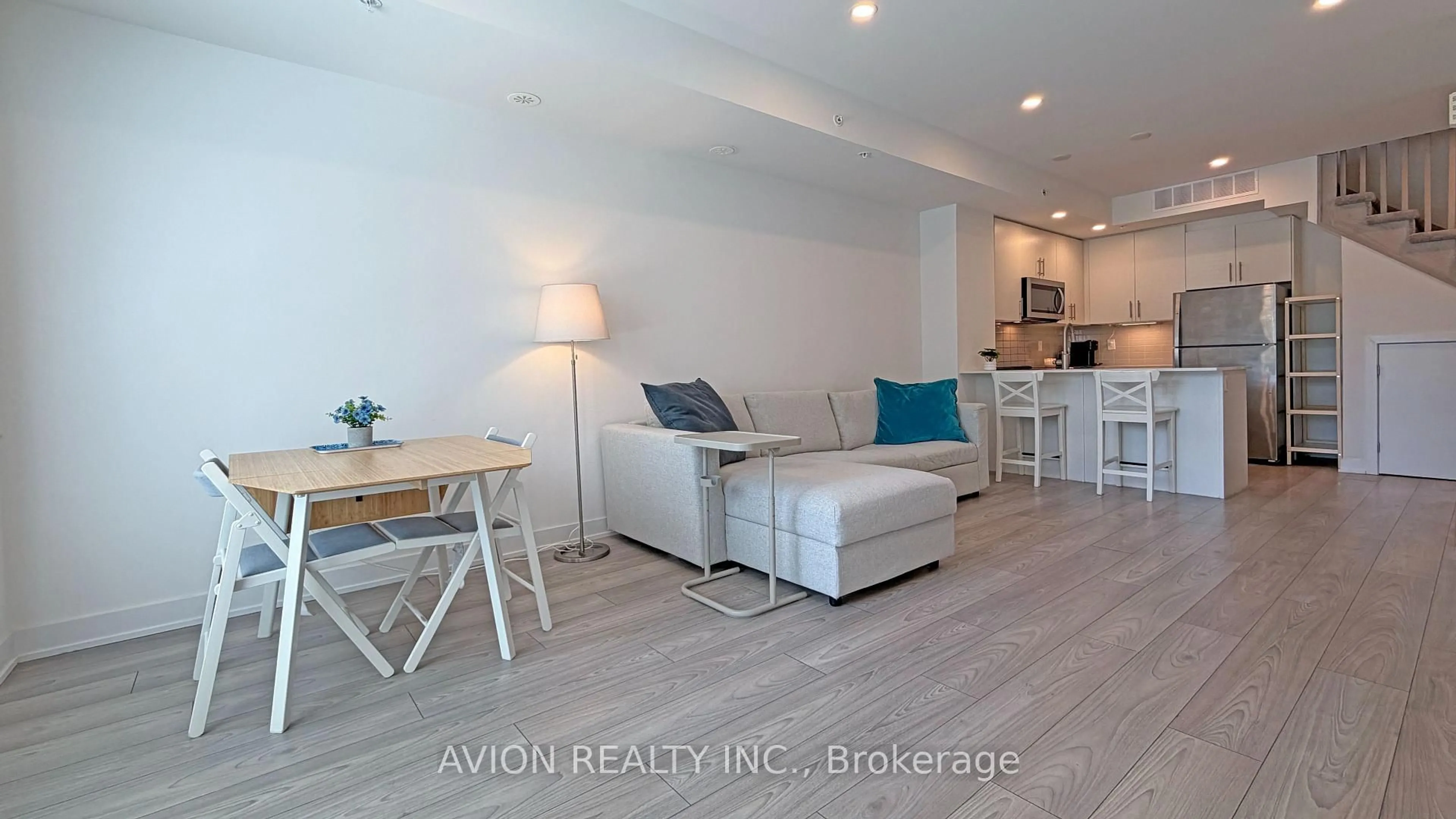 Living room with furniture, wood/laminate floor for 3473 Widdicombe Way #8, Mississauga Ontario L5L 0B8