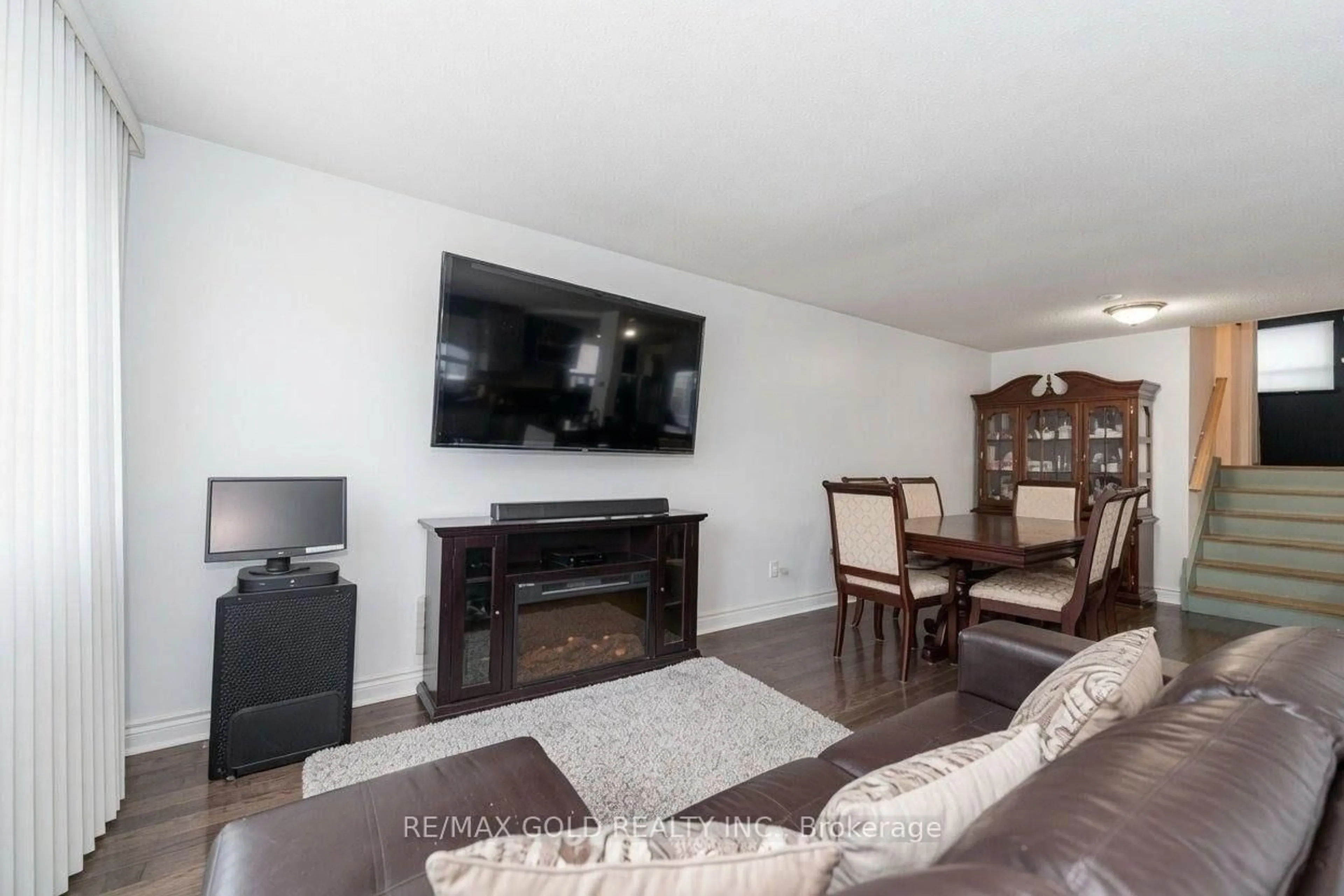 Living room with furniture, wood/laminate floor for 63 Newstead Cres, Brampton Ontario L6V 2A8