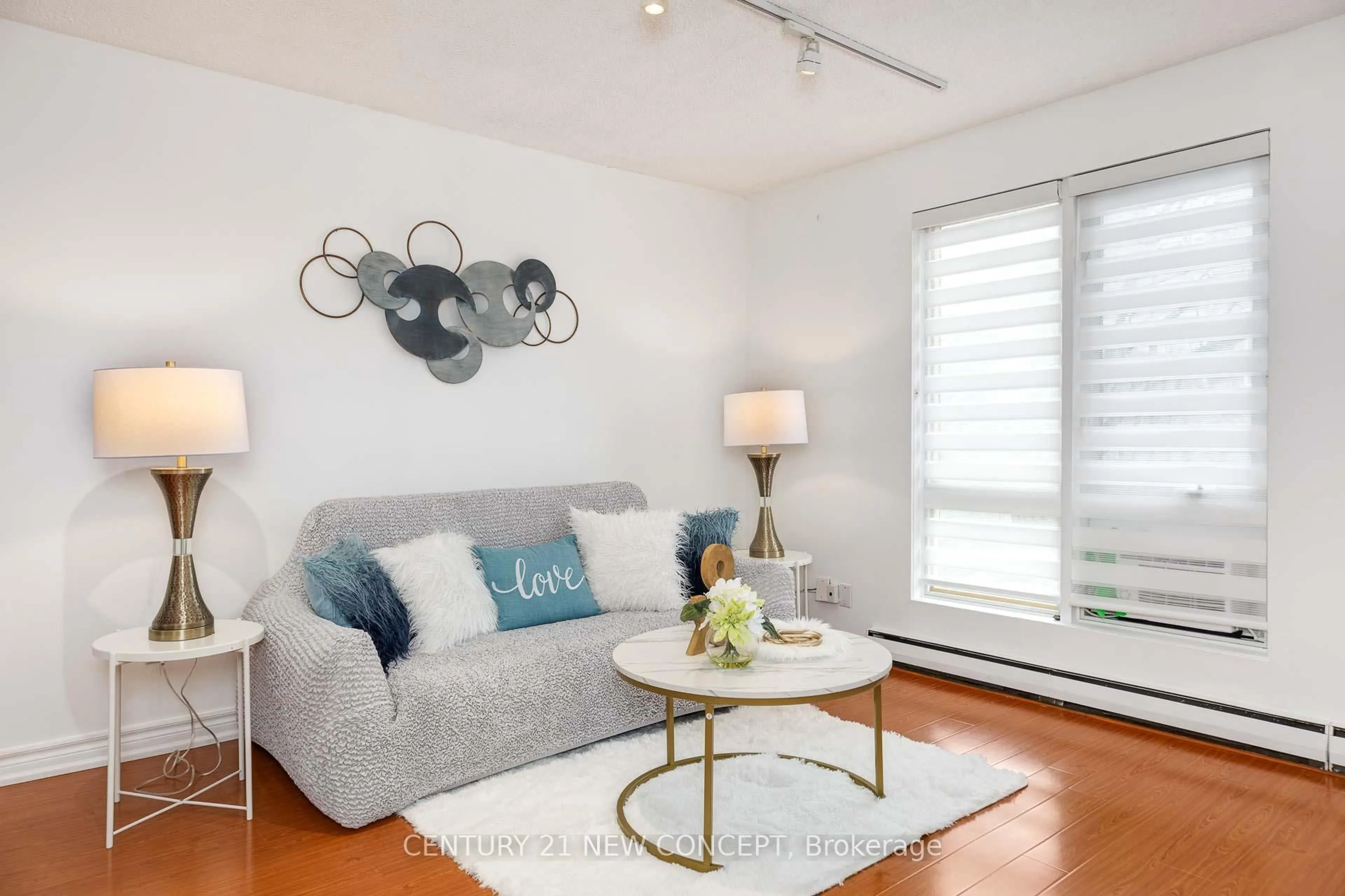 Living room with furniture, wood/laminate floor for 1310 Gulleden Dr #13, Mississauga Ontario L4X 1Y9