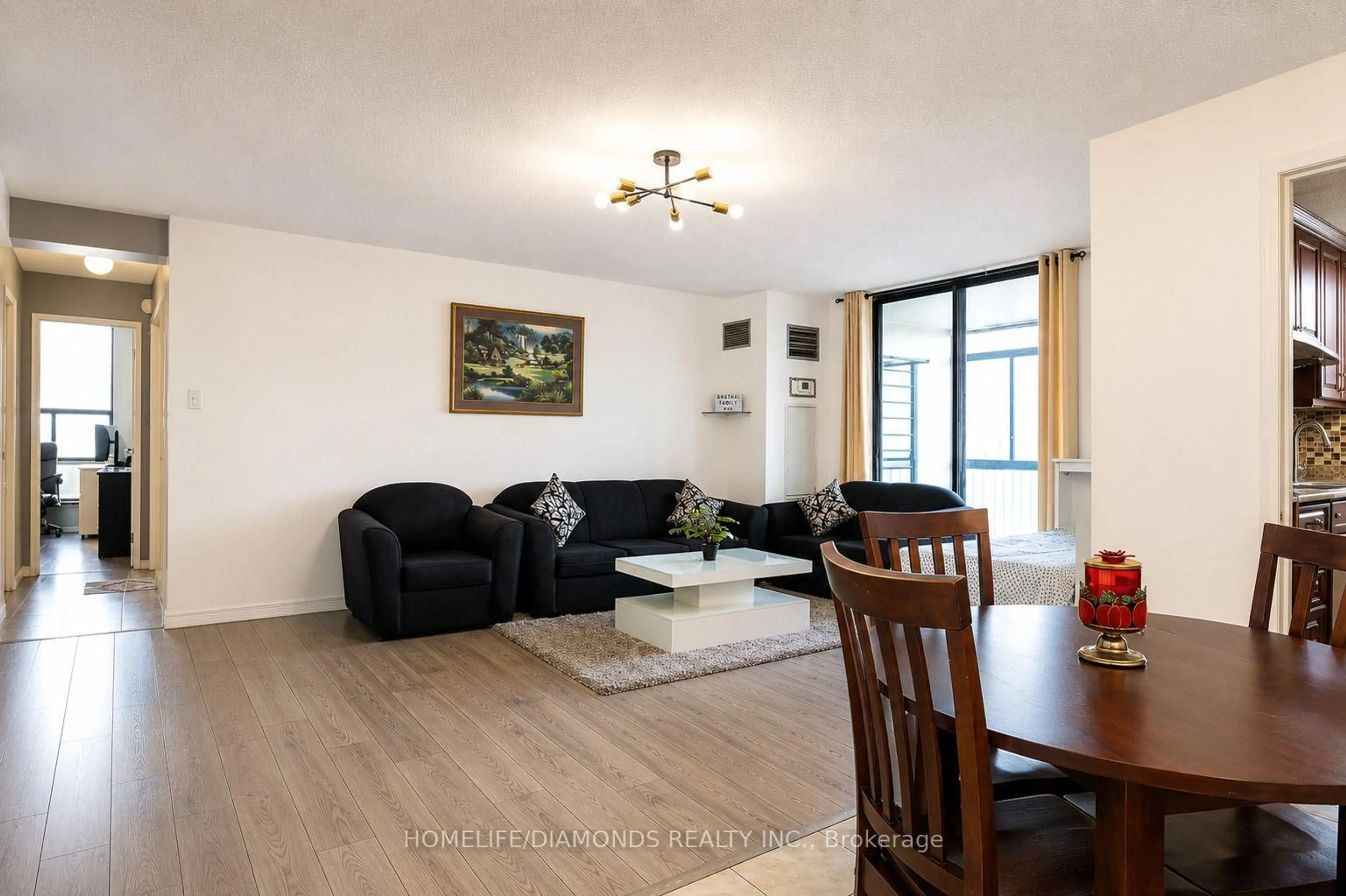 Living room with furniture, wood/laminate floor for 18 Knightsbridge Rd #1411, Brampton Ontario L6T 3X5