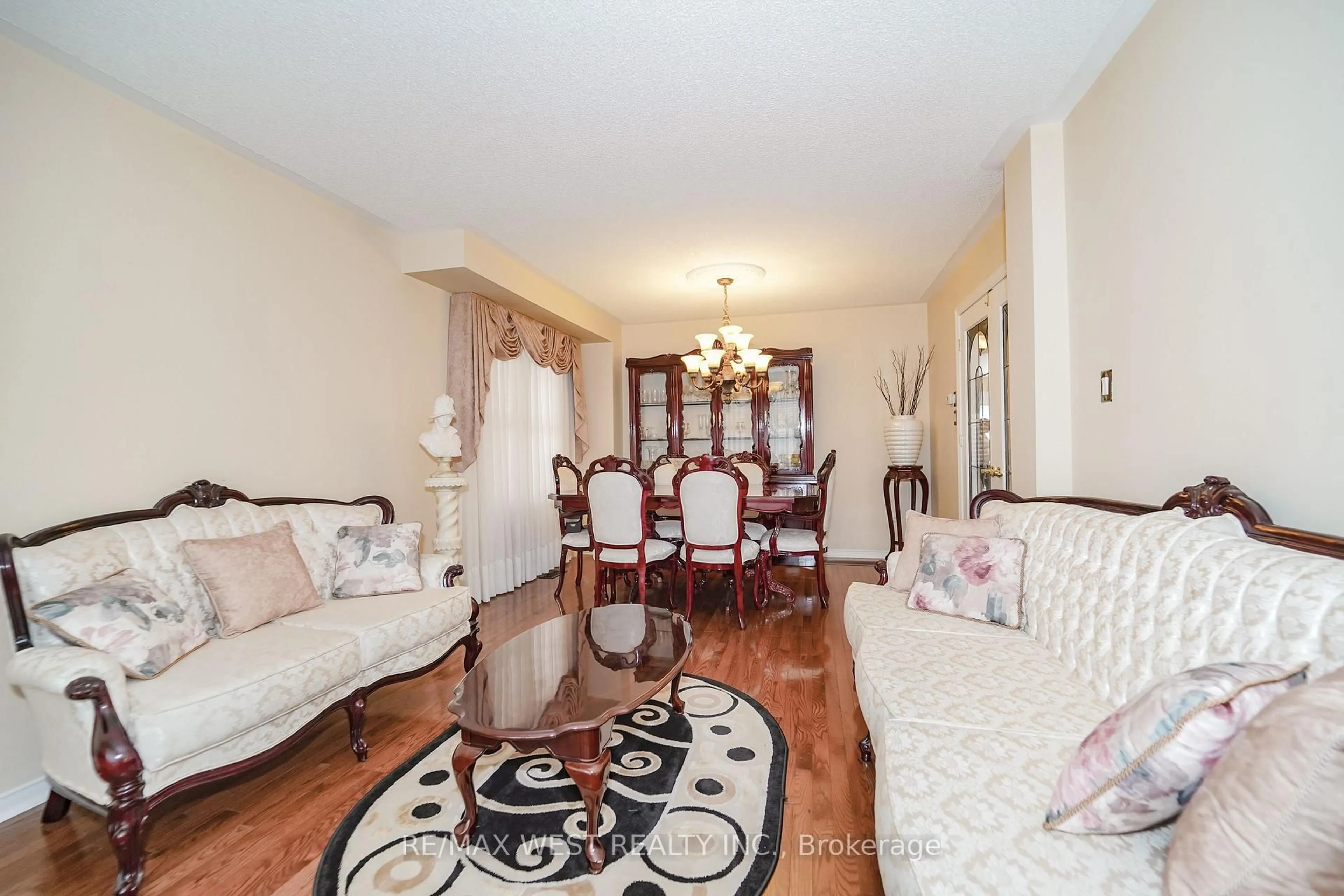 Living room with furniture, wood/laminate floor for 63 Lockheed Cres, Brampton Ontario L7A 3G4