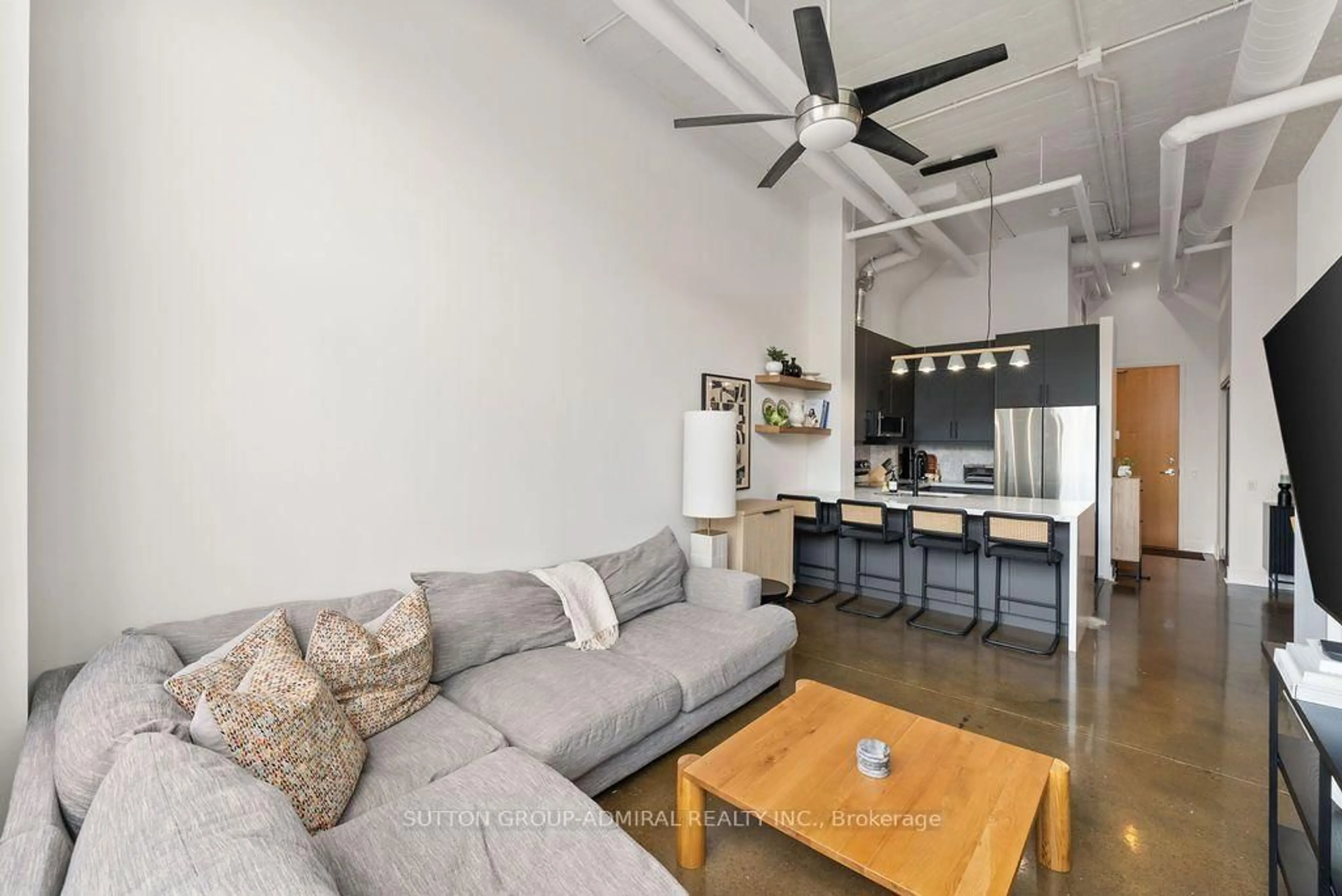 Living room with furniture, cement floor for 1001 Roselawn Ave #124, Toronto Ontario M6B 4M4