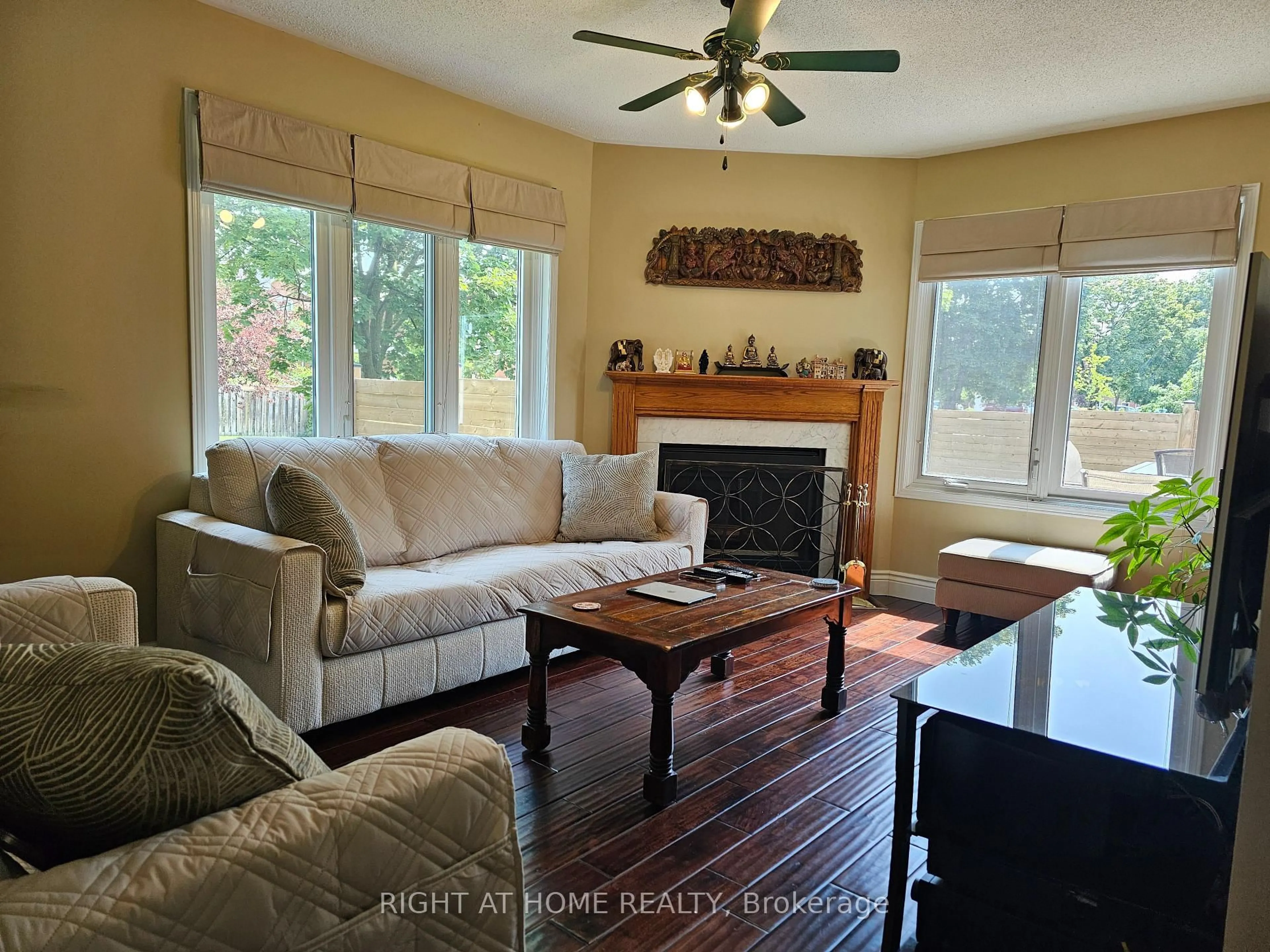 Living room with furniture, wood/laminate floor for 710 Ashprior Ave, Mississauga Ontario L5R 3N8