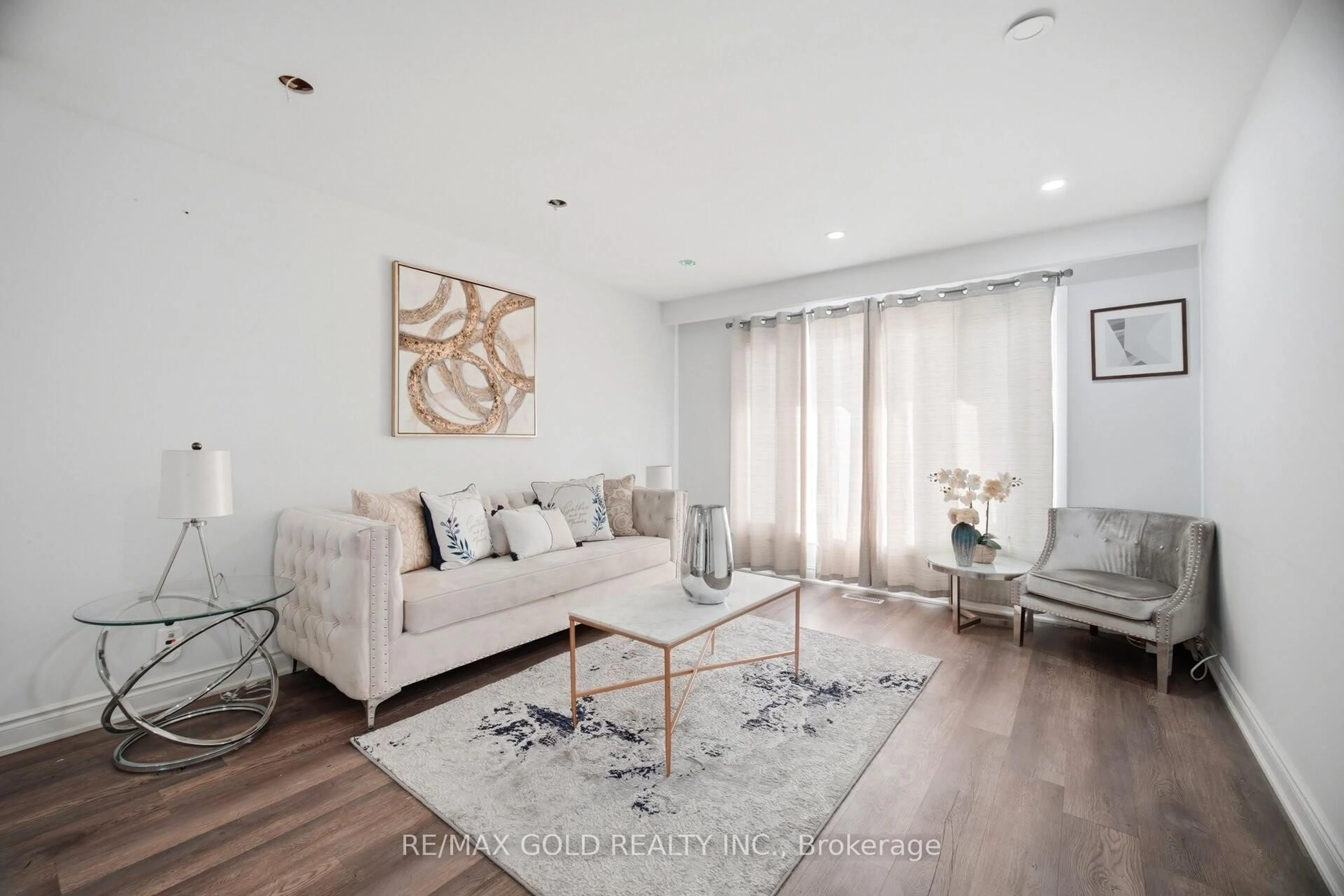 Living room with furniture, wood/laminate floor for 3345 Monica Dr, Mississauga Ontario L4T 3E6