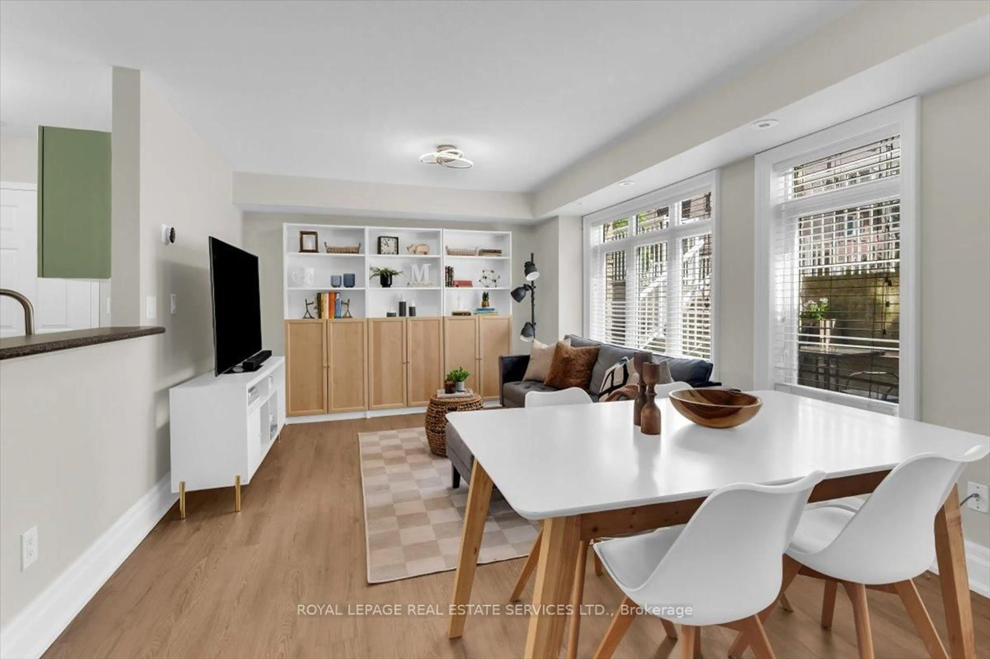 Living room with furniture, wood/laminate floor for 30 Turntable Cres #36, Toronto Ontario M6H 4K9