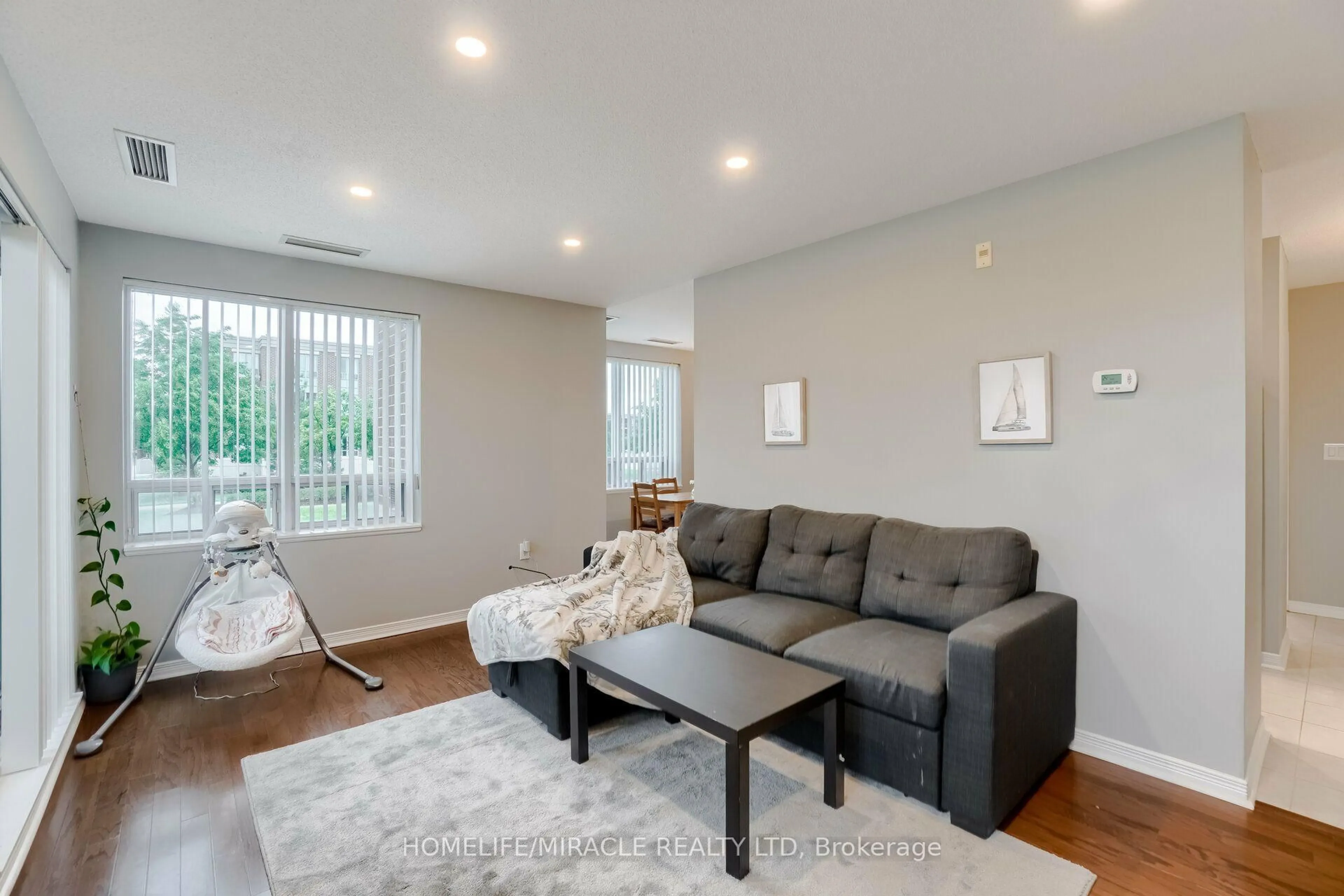 Living room with furniture, wood/laminate floor for 55 Via Rosedale Rd #105, Brampton Ontario L6R 0V1