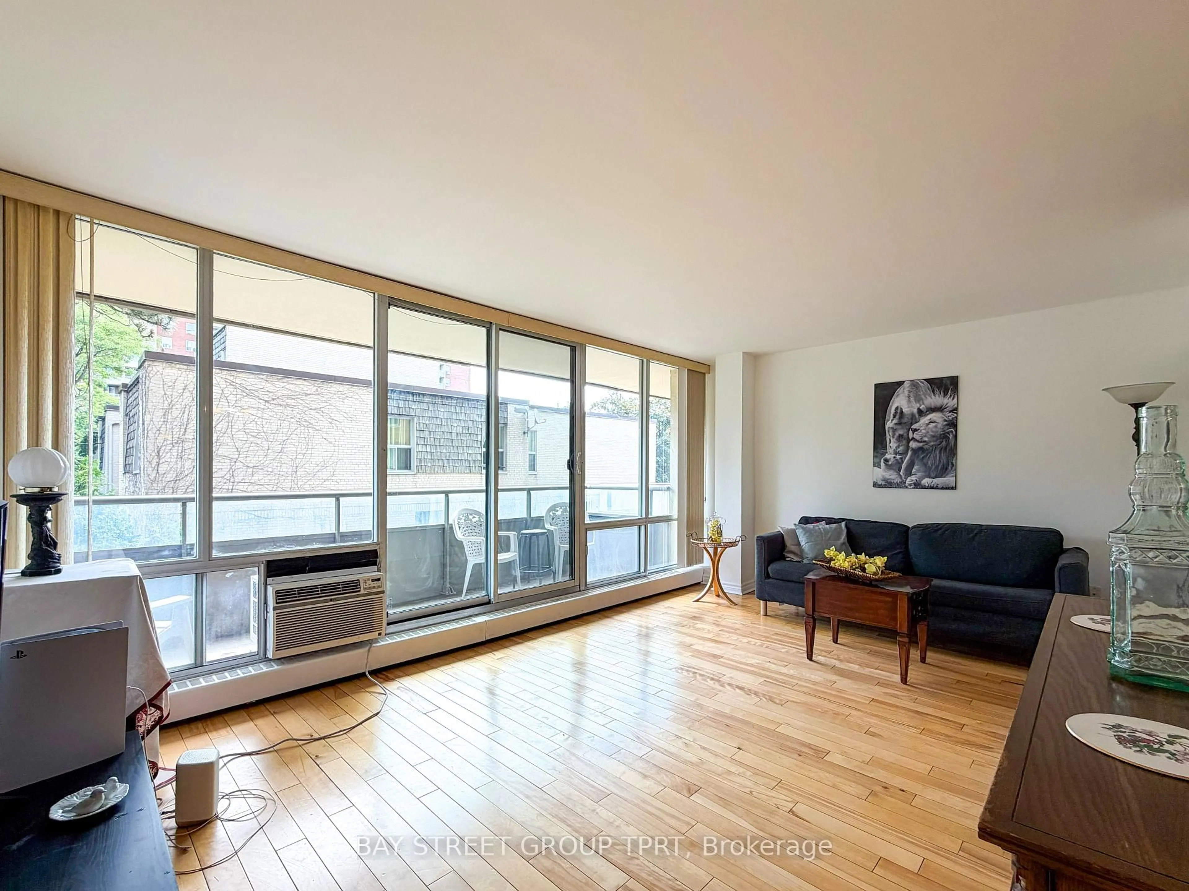 Living room with furniture, wood/laminate floor for 9 Four Winds Dr #208, Toronto Ontario M3J 2S8