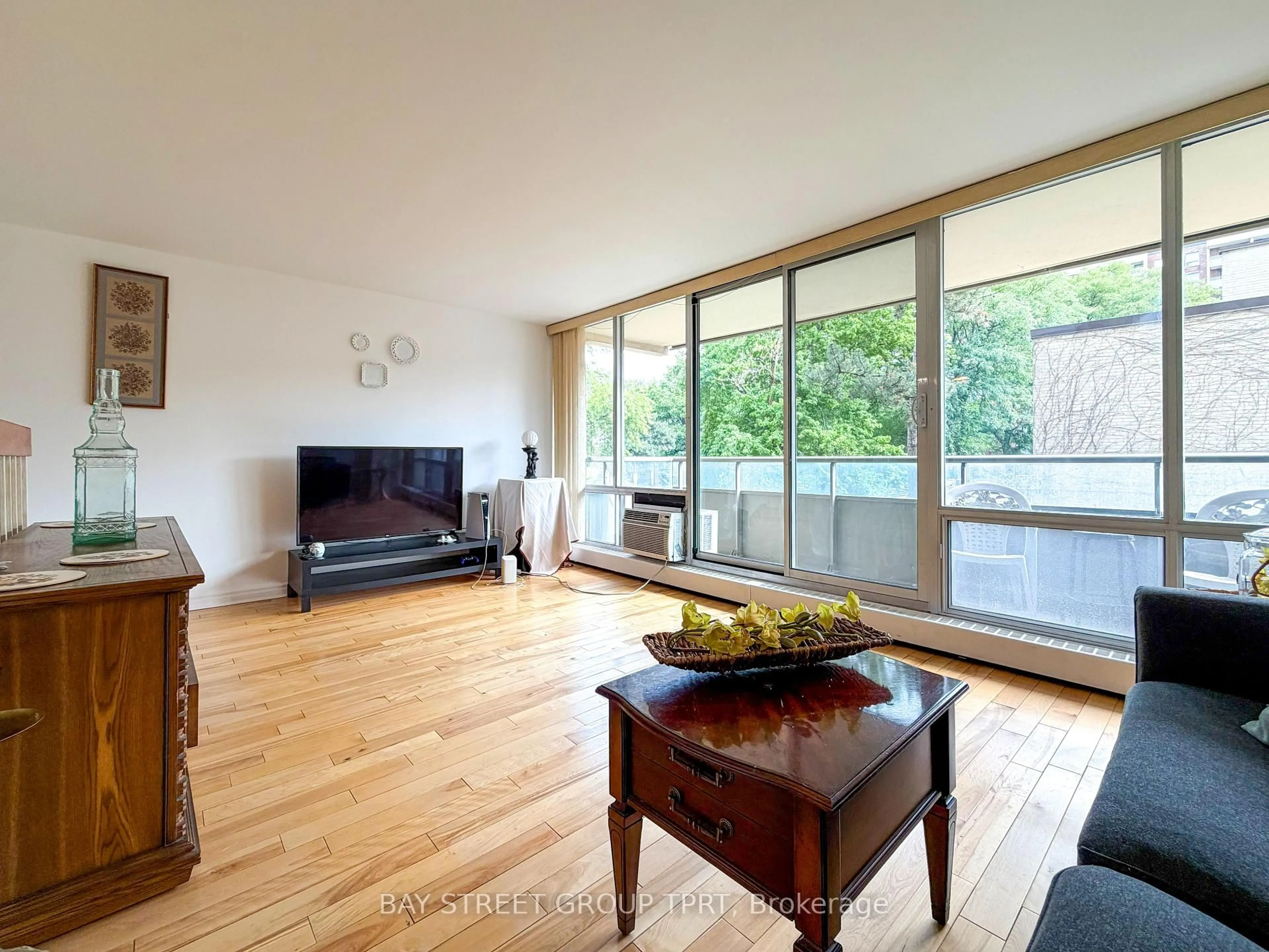 Living room with furniture, wood/laminate floor for 9 Four Winds Dr #208, Toronto Ontario M3J 2S8