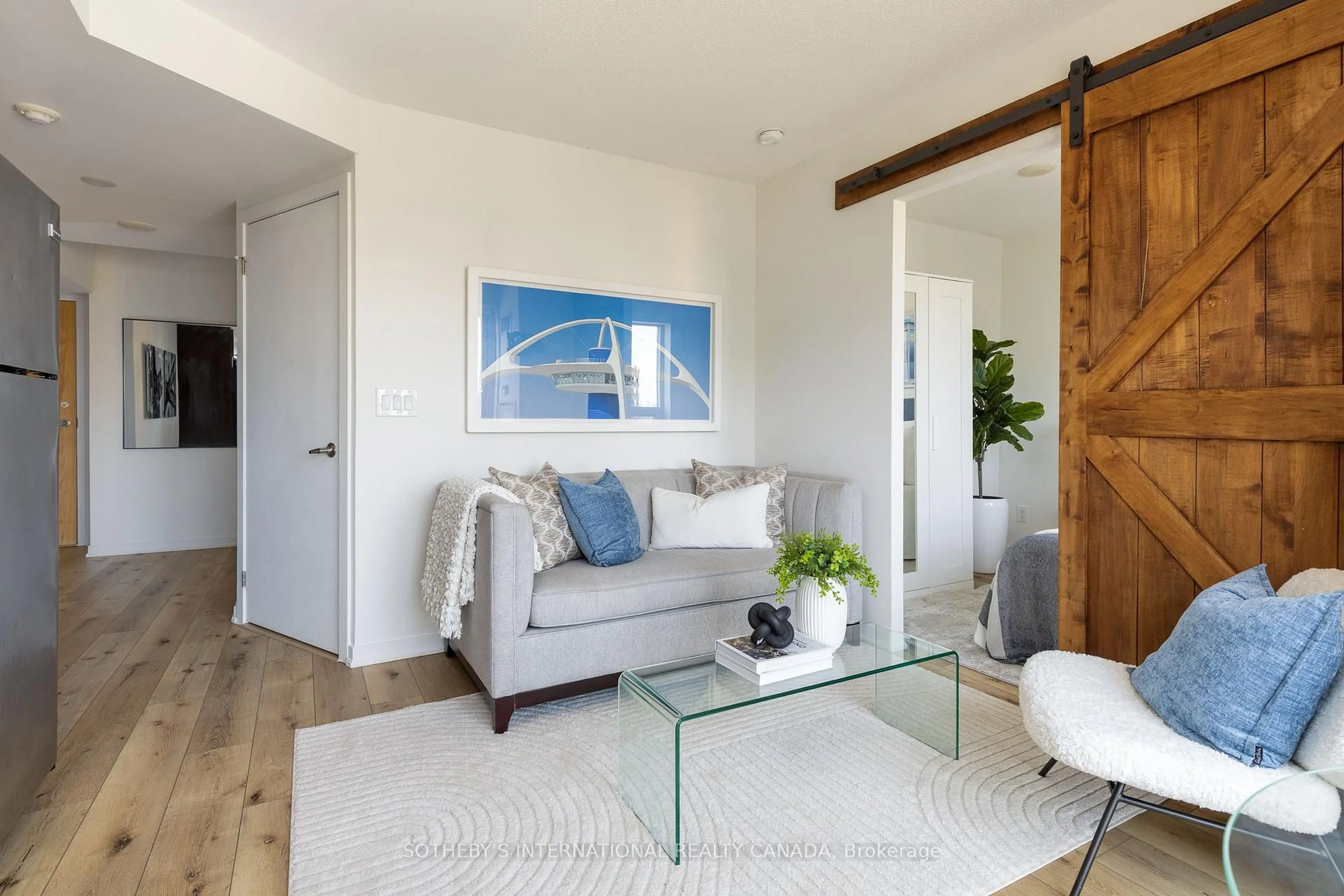 Living room with furniture, wood/laminate floor for 38 Joe Shuster Way #1619, Toronto Ontario M6K 0A5