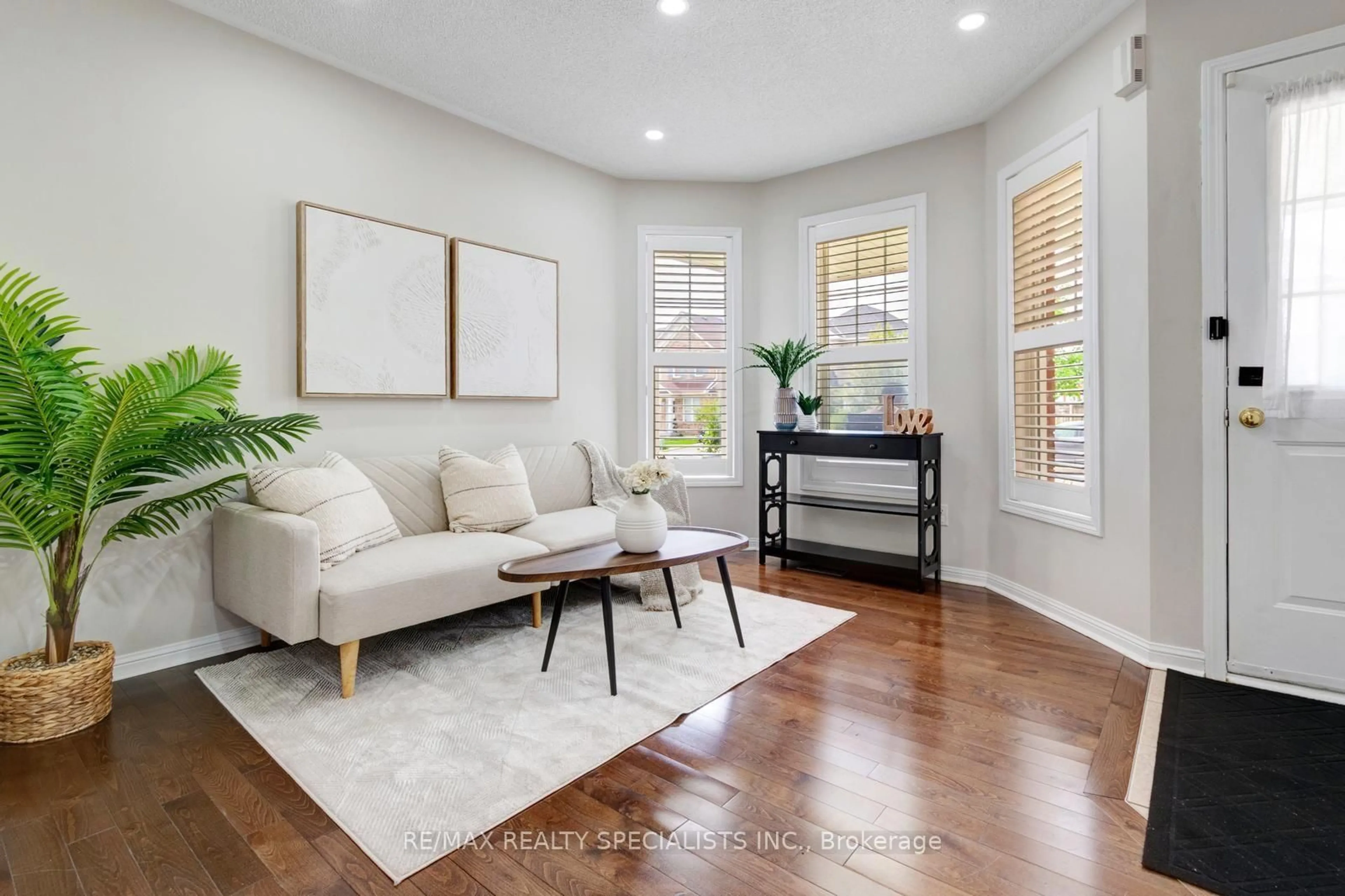Living room with furniture, wood/laminate floor for 38 Sweetwood Circ, Brampton Ontario L7A 2X7