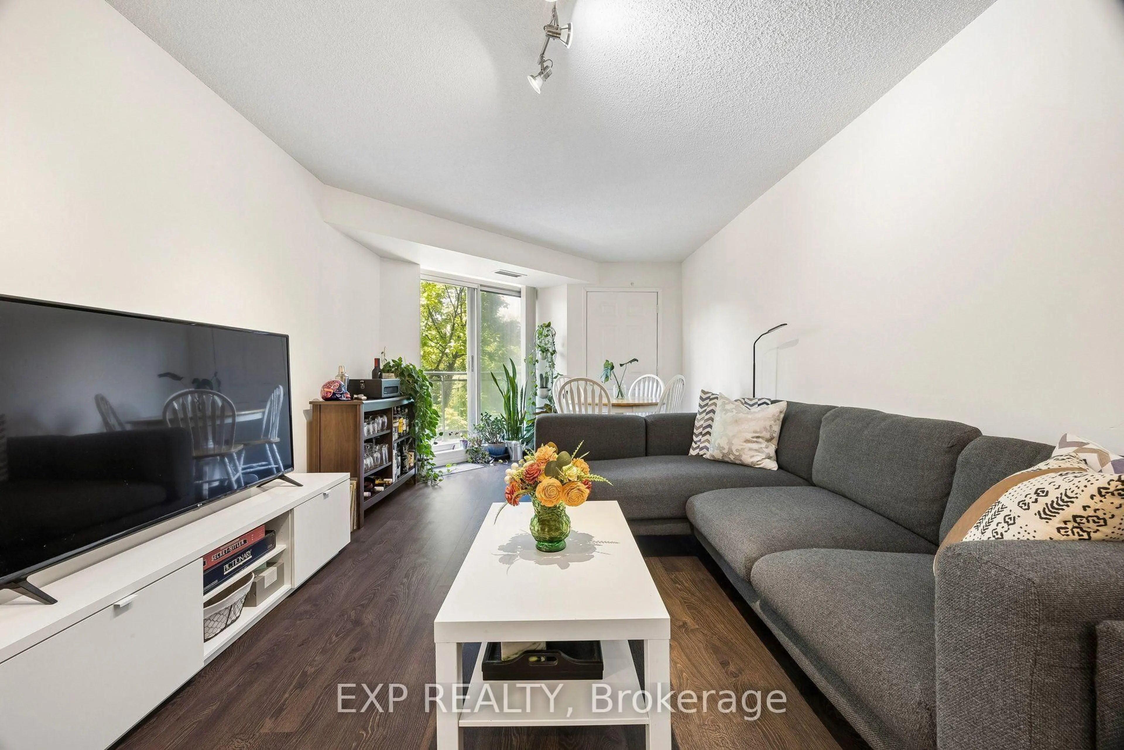 Living room with furniture, wood/laminate floor for 190 Manitoba St #311, Toronto Ontario M8Y 3Y8