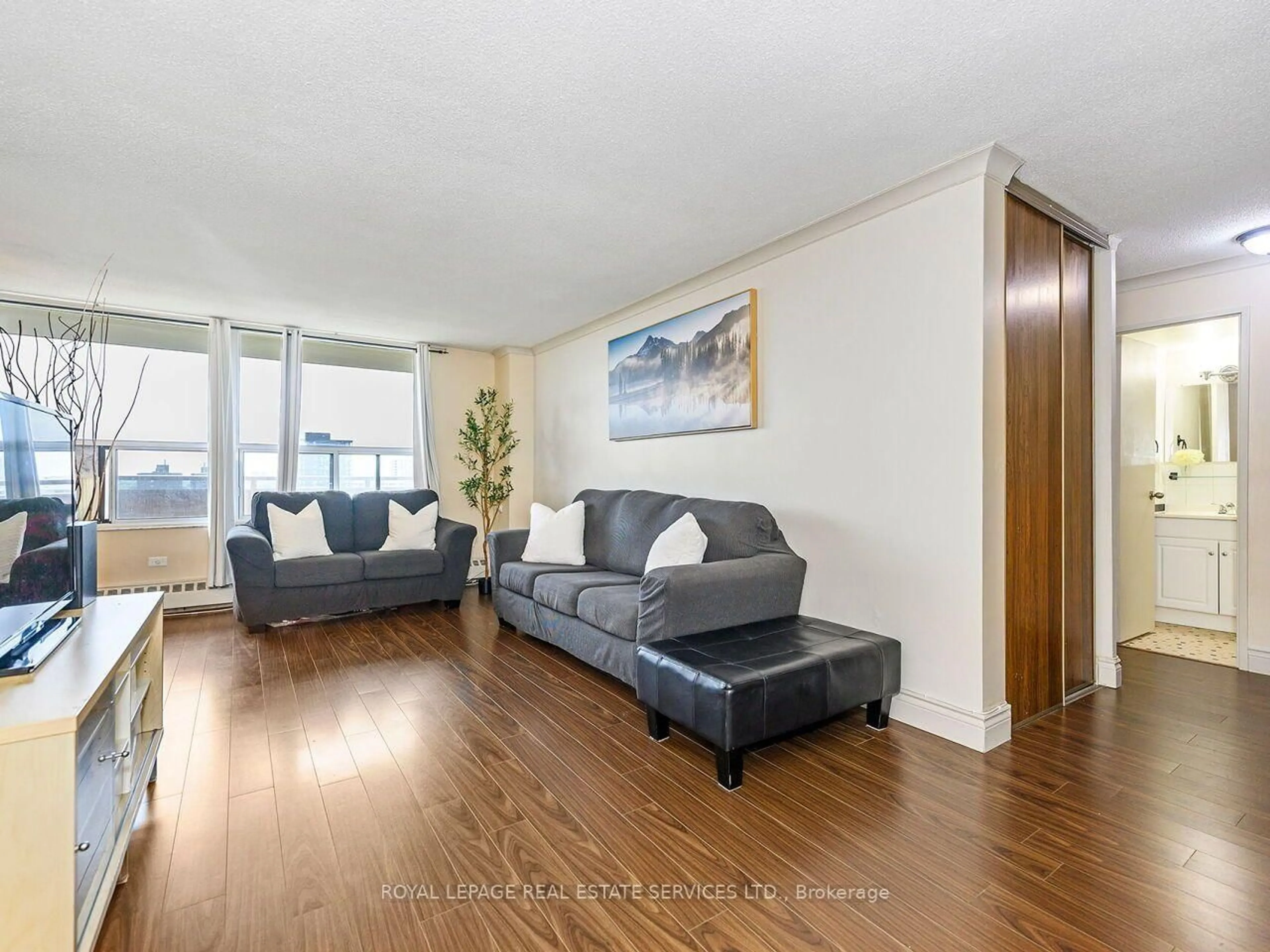 Living room with furniture, wood/laminate floor for 3120 Kirwin Ave #1109, Mississauga Ontario L5A 3R2