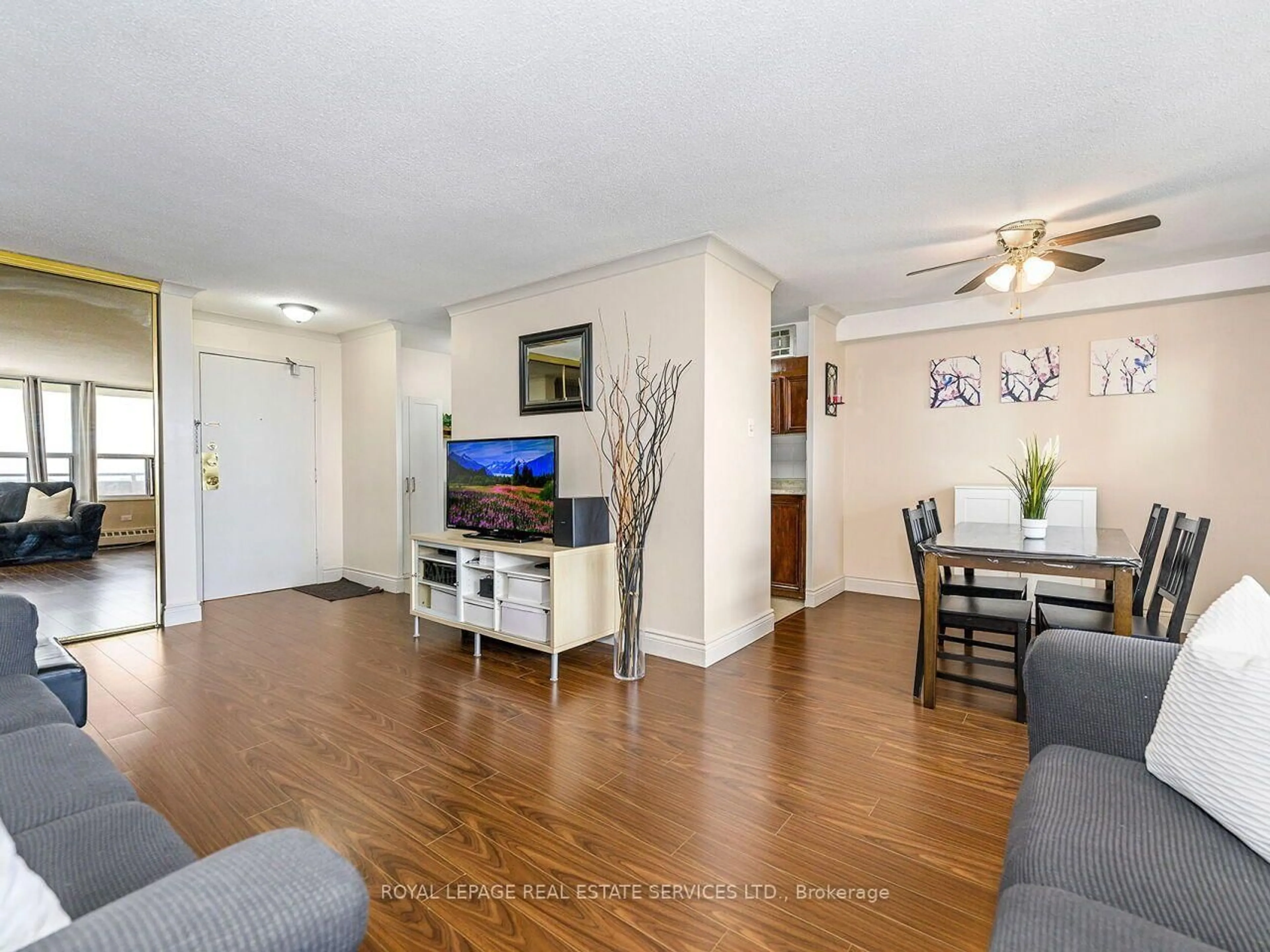 Living room with furniture, wood/laminate floor for 3120 Kirwin Ave #1109, Mississauga Ontario L5A 3R2