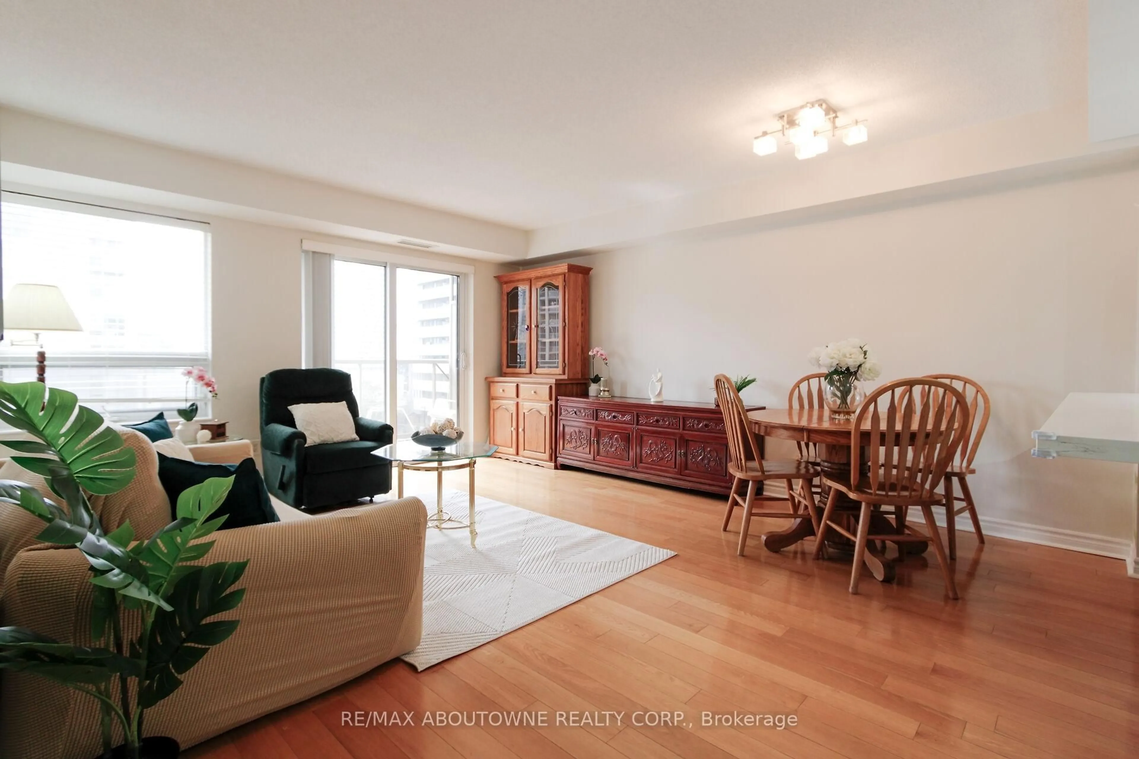 Living room with furniture, wood/laminate floor for 350 Princess Royal Dr #1002, Mississauga Ontario L5B 4N1