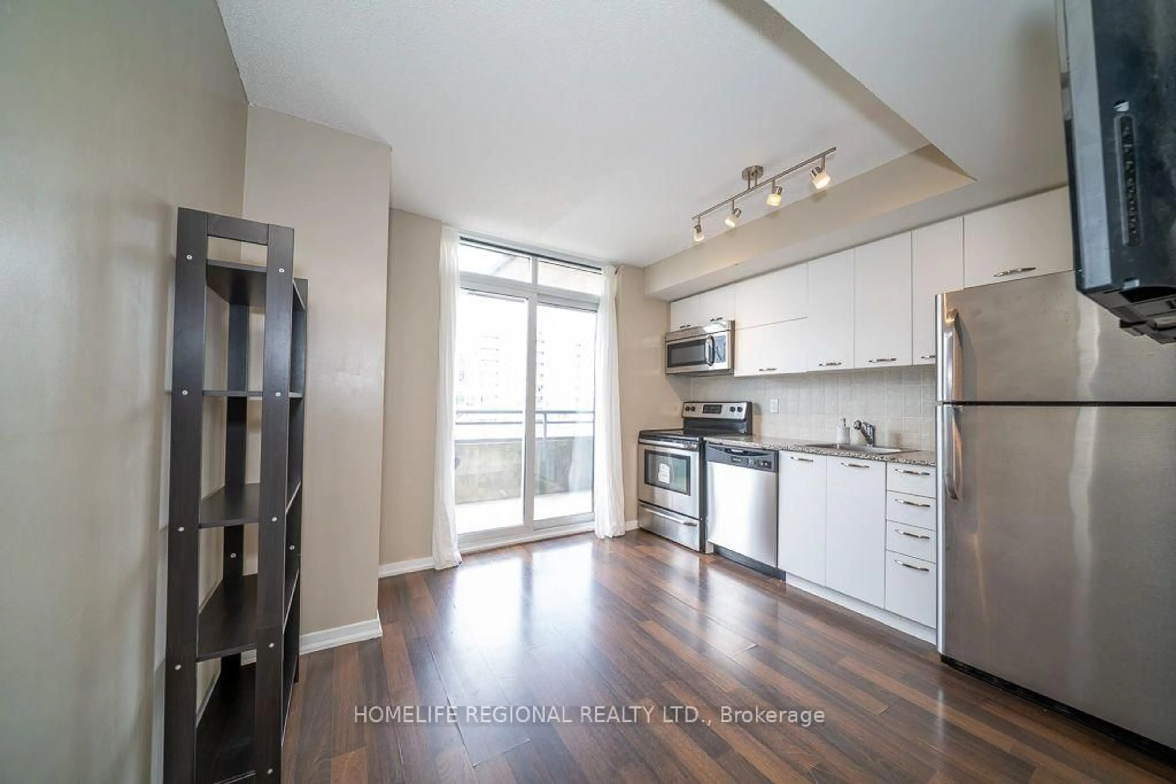 Open concept kitchen, wood/laminate floor for 38 Joe Shuster Way #1520, Toronto Ontario M6K 0A5