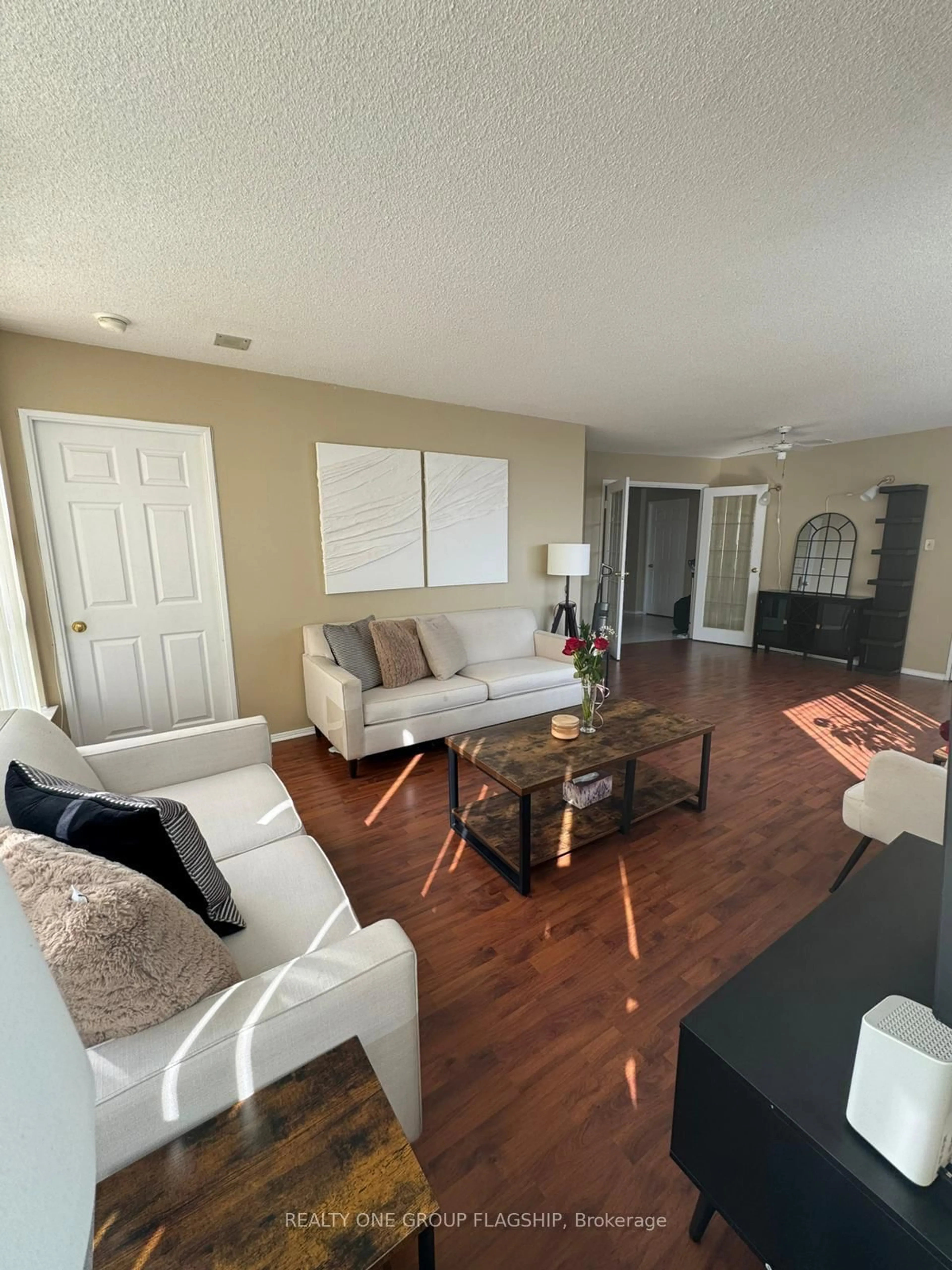 Living room with furniture, wood/laminate floor for 55 Elm Dr #604, Mississauga Ontario L5B 3Z3