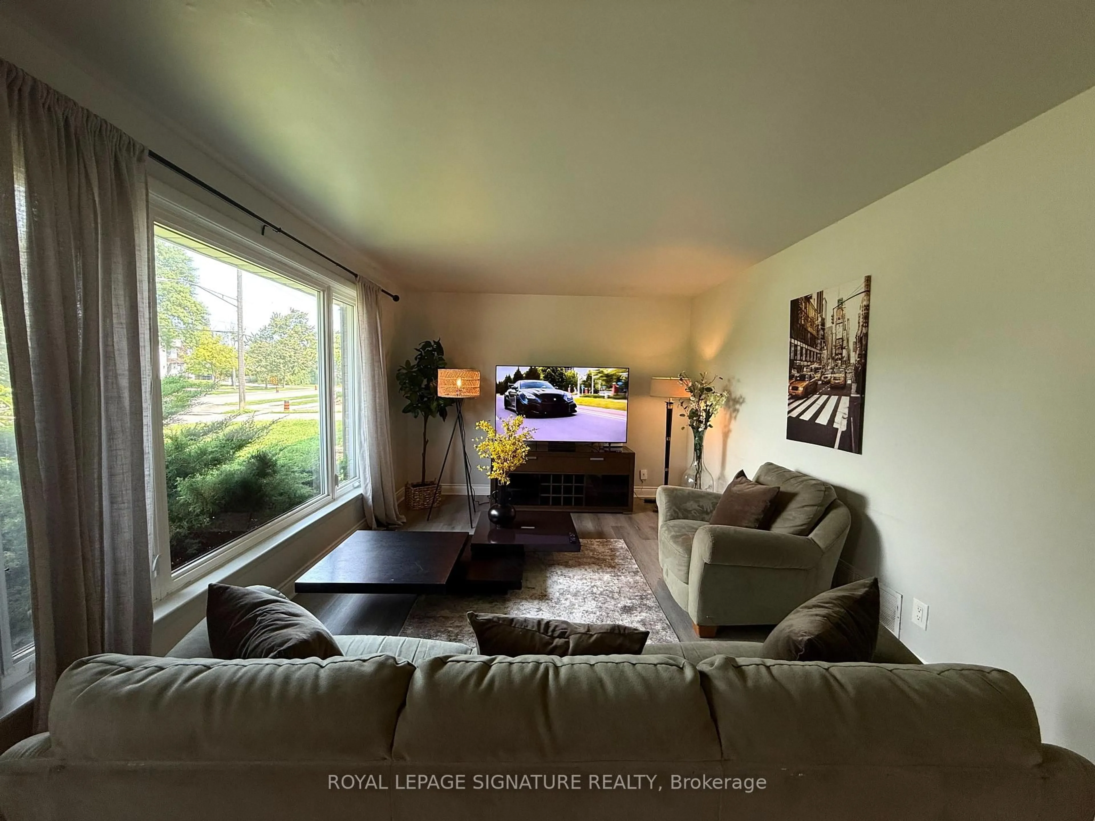 Living room with furniture, wood/laminate floor for 1350 Rebecca St, Oakville Ontario L6L 1Z4