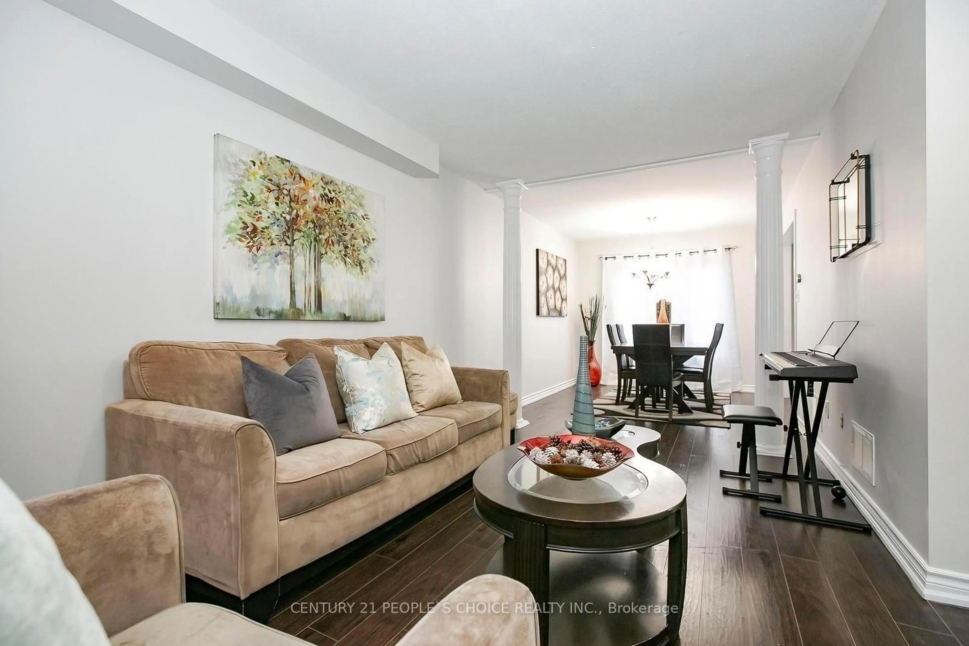 Living room with furniture, wood/laminate floor for 90 White Tail Cres, Brampton Ontario L6Y 5B9