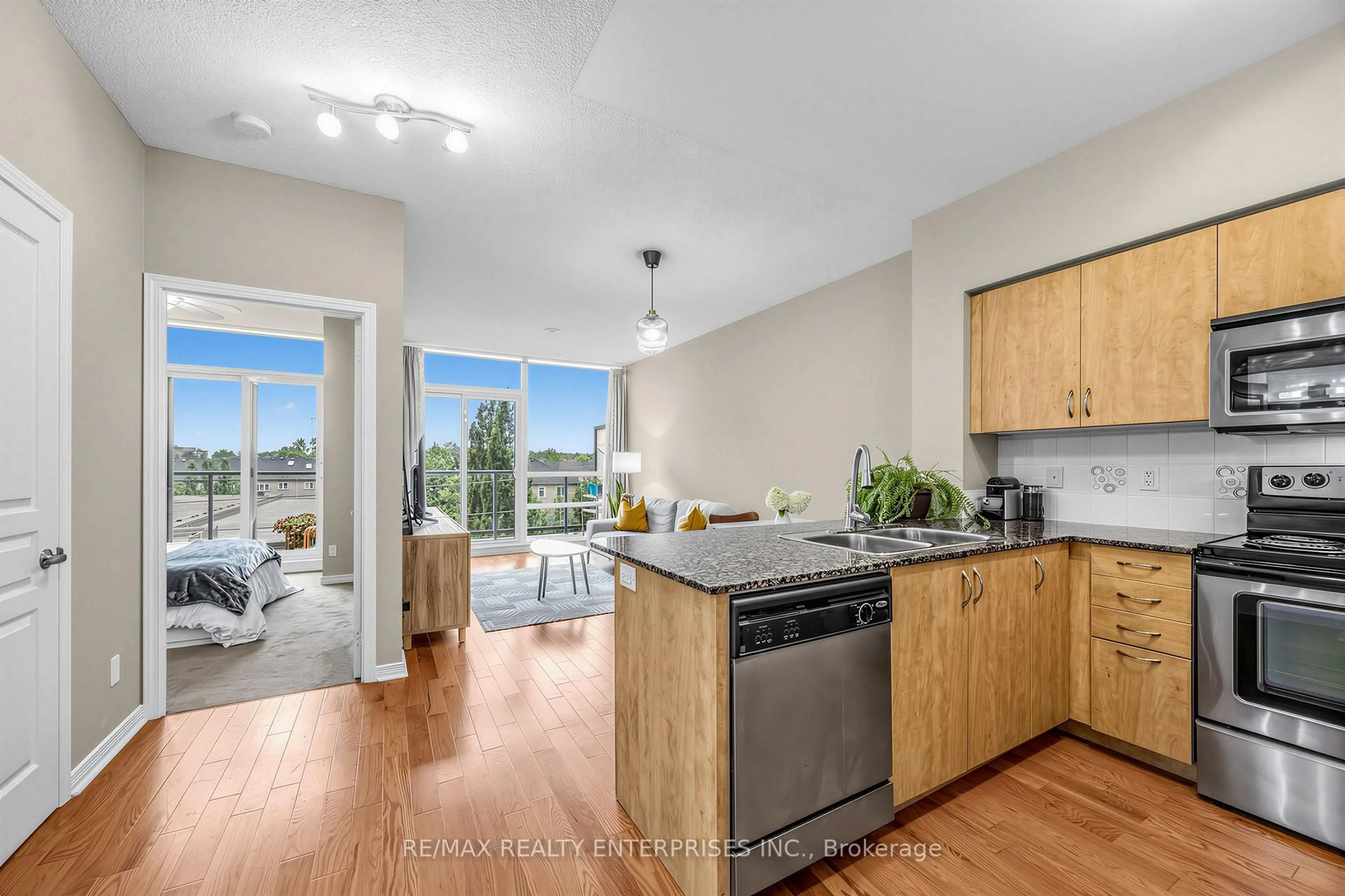 Open concept kitchen, wood/laminate floor for 15 Legion Rd #304, Toronto Ontario M8V 0A9
