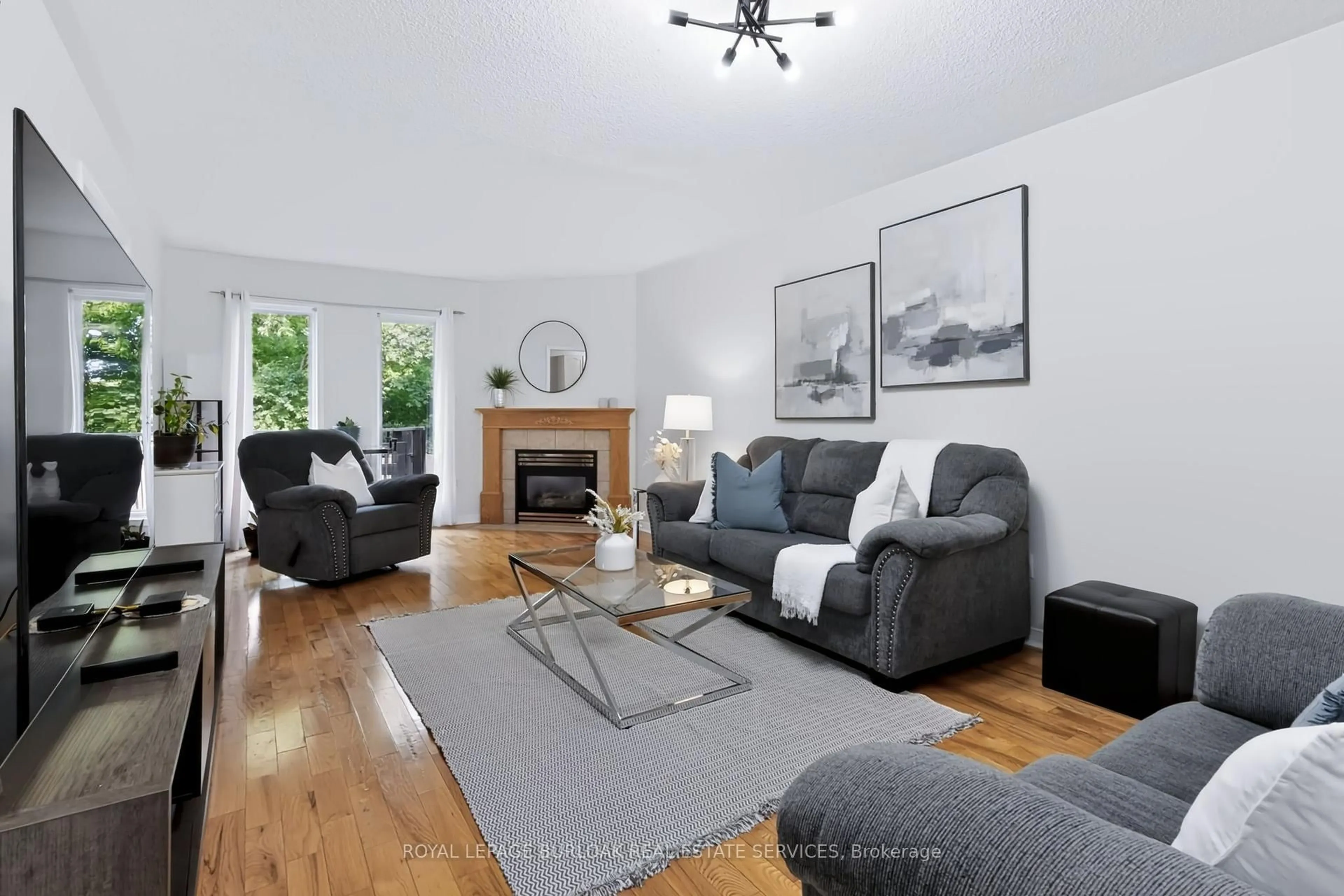 Living room with furniture, wood/laminate floor for 4130 Foxwood Dr, Burlington Ontario L7M 4L3