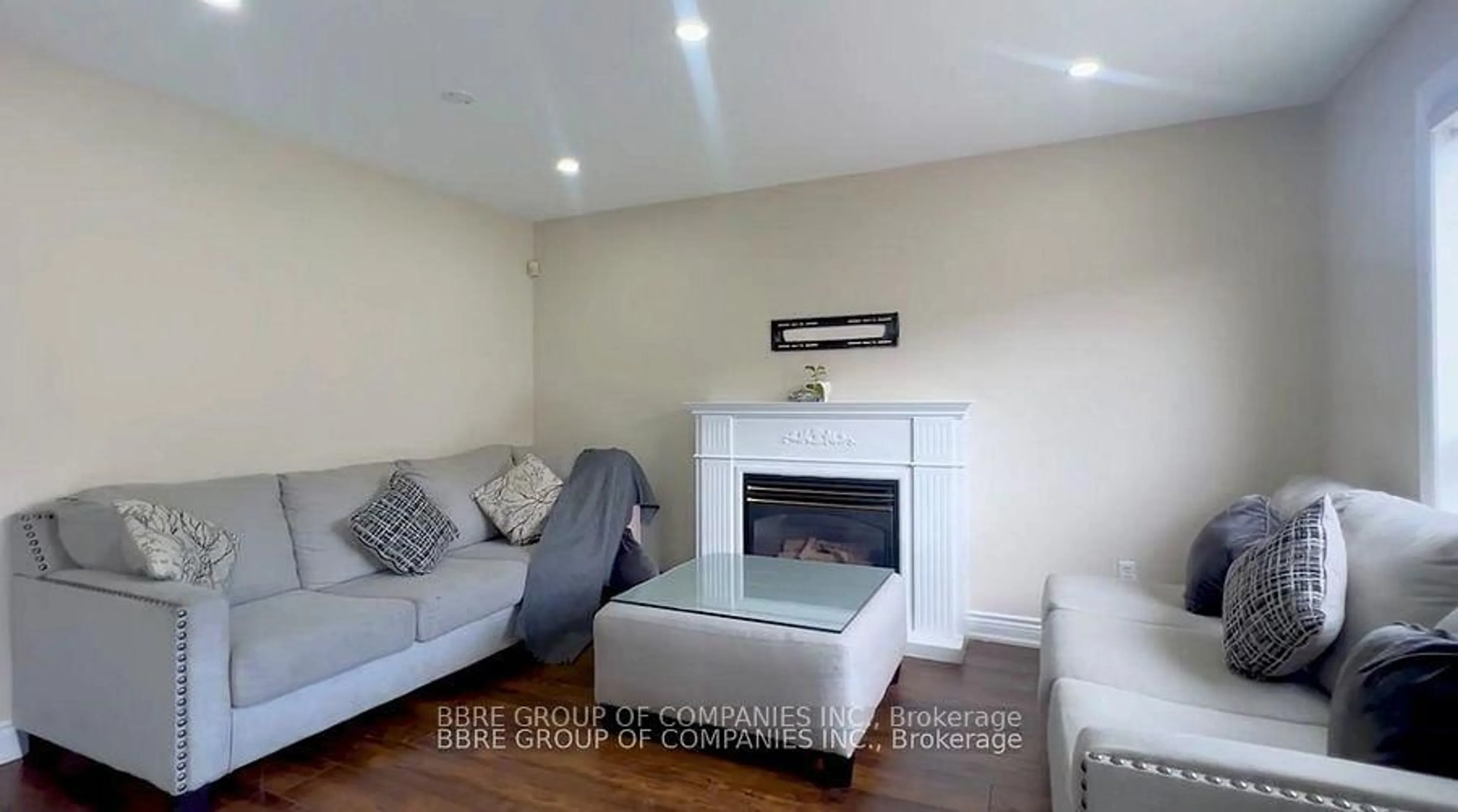 Living room with furniture, wood/laminate floor for 25 GOLDEN EAGLE Rd, Brampton Ontario L6R 1Z4