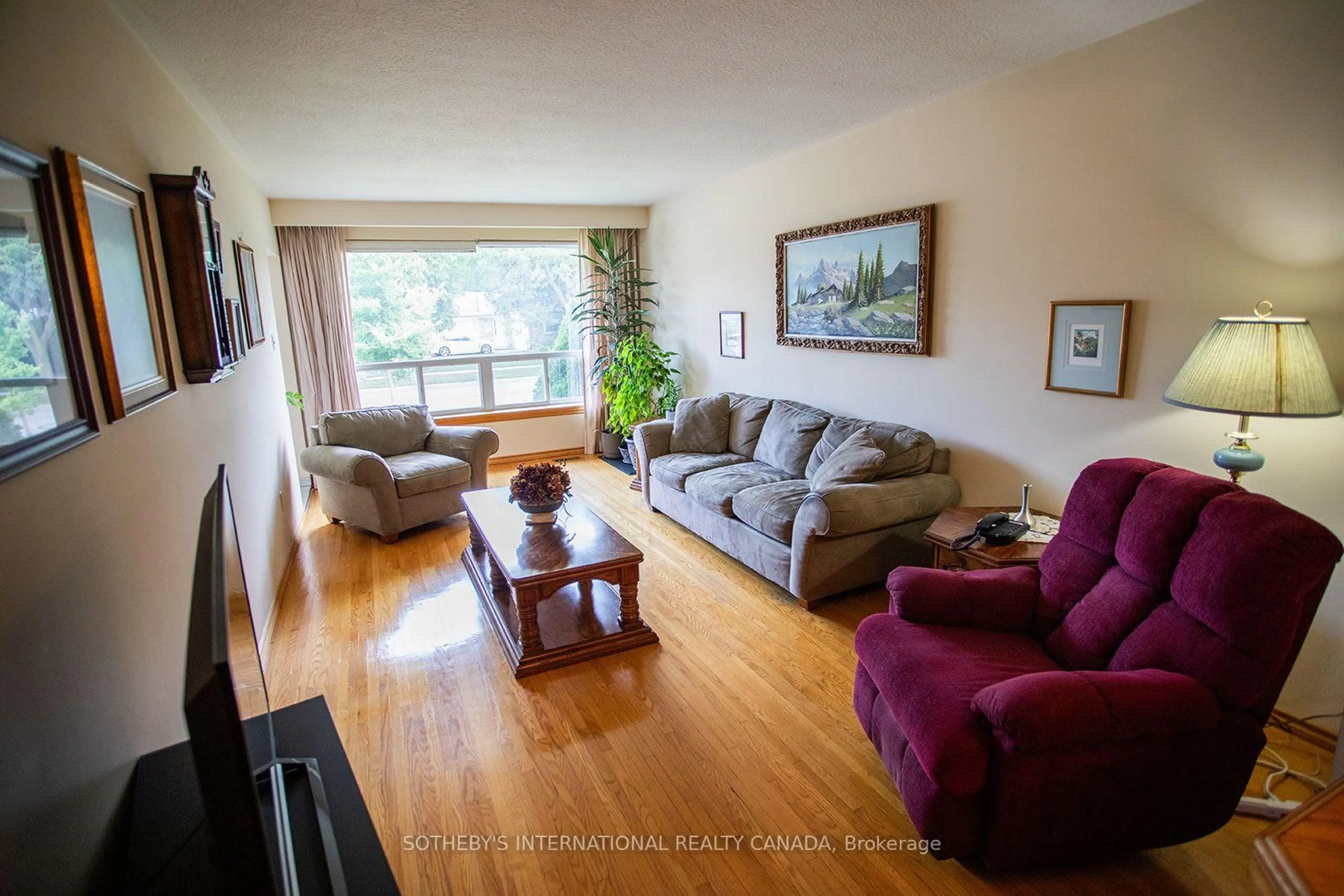 Living room with furniture, wood/laminate floor for 12 Waterbury Dr, Toronto Ontario M9R 3X6