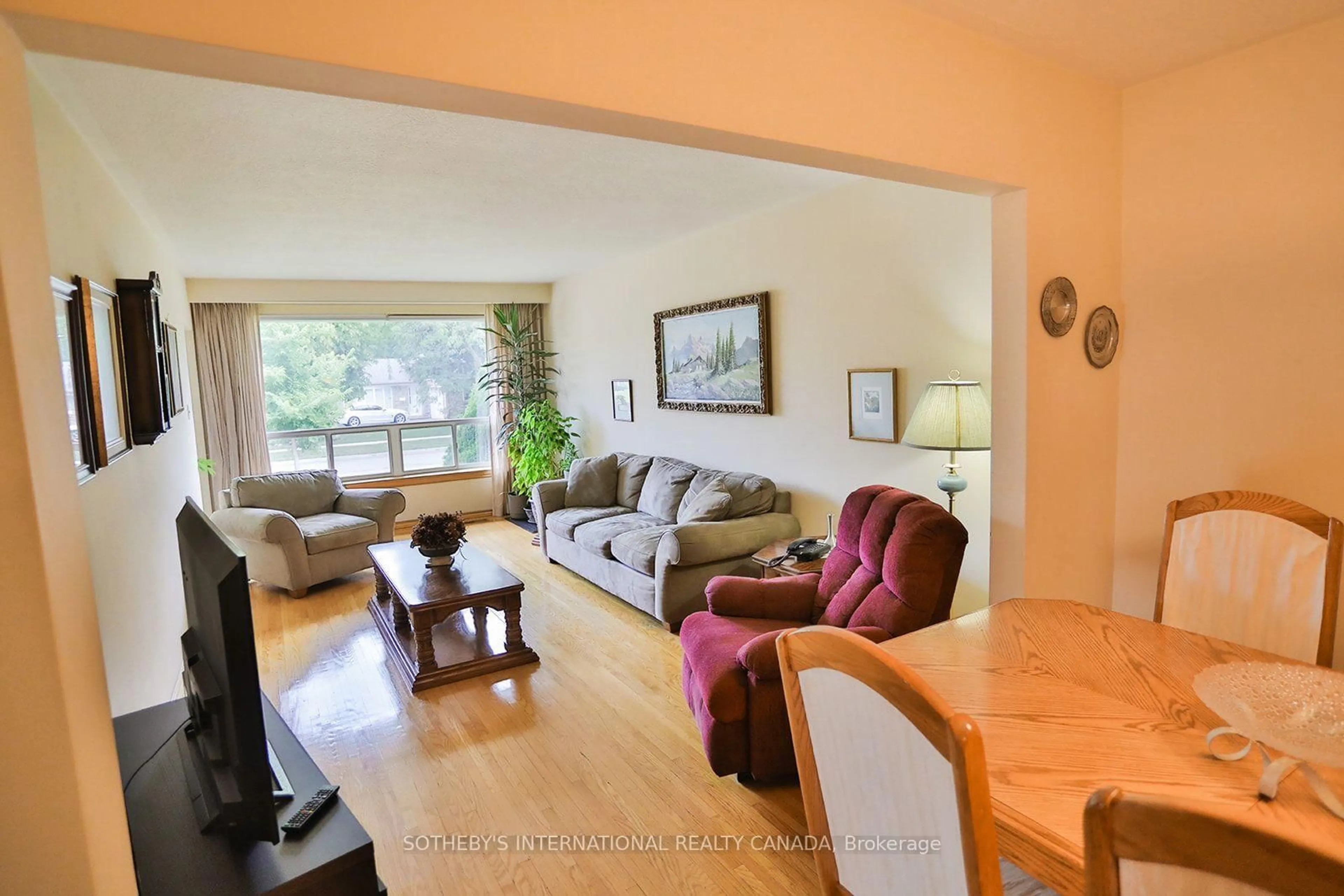 Living room with furniture, wood/laminate floor for 12 Waterbury Dr, Toronto Ontario M9R 3X6