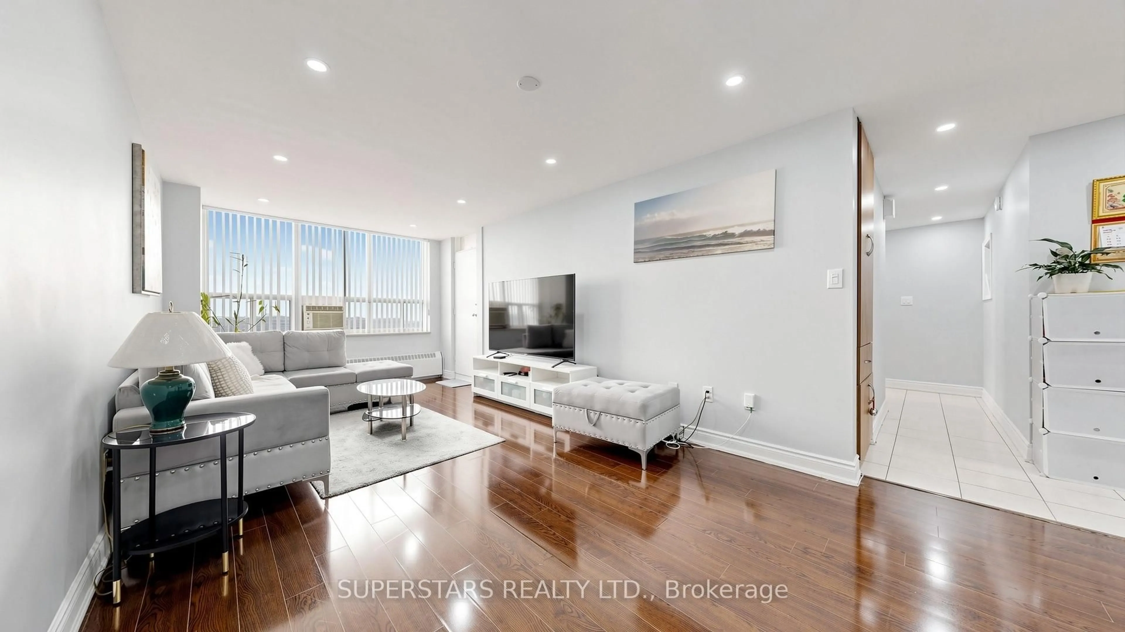 Living room with furniture, wood/laminate floor for 390 Dixon Rd #1906, Toronto Ontario M9R 1T4