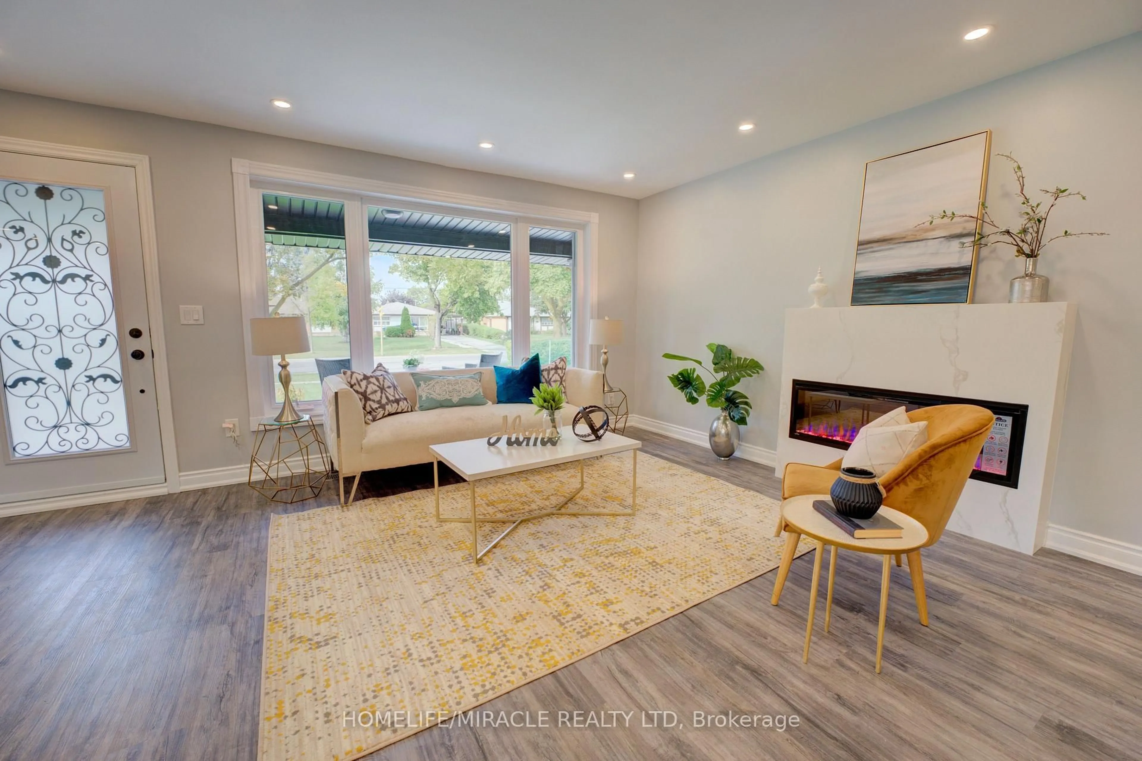 Living room with furniture, wood/laminate floor for 85 Silverstone Dr, Toronto Ontario M9V 3G4