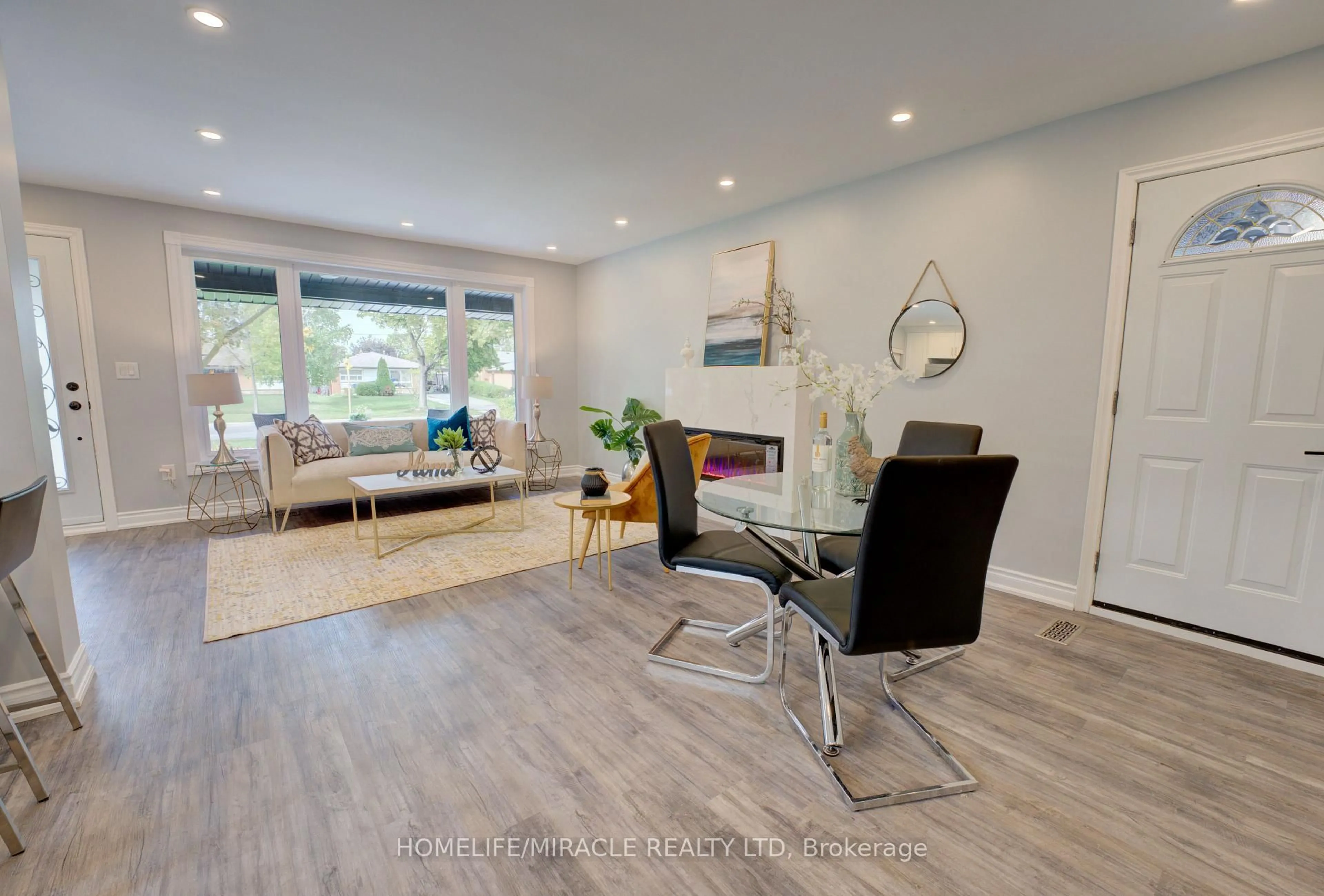 Living room with furniture, wood/laminate floor for 85 Silverstone Dr, Toronto Ontario M9V 3G4