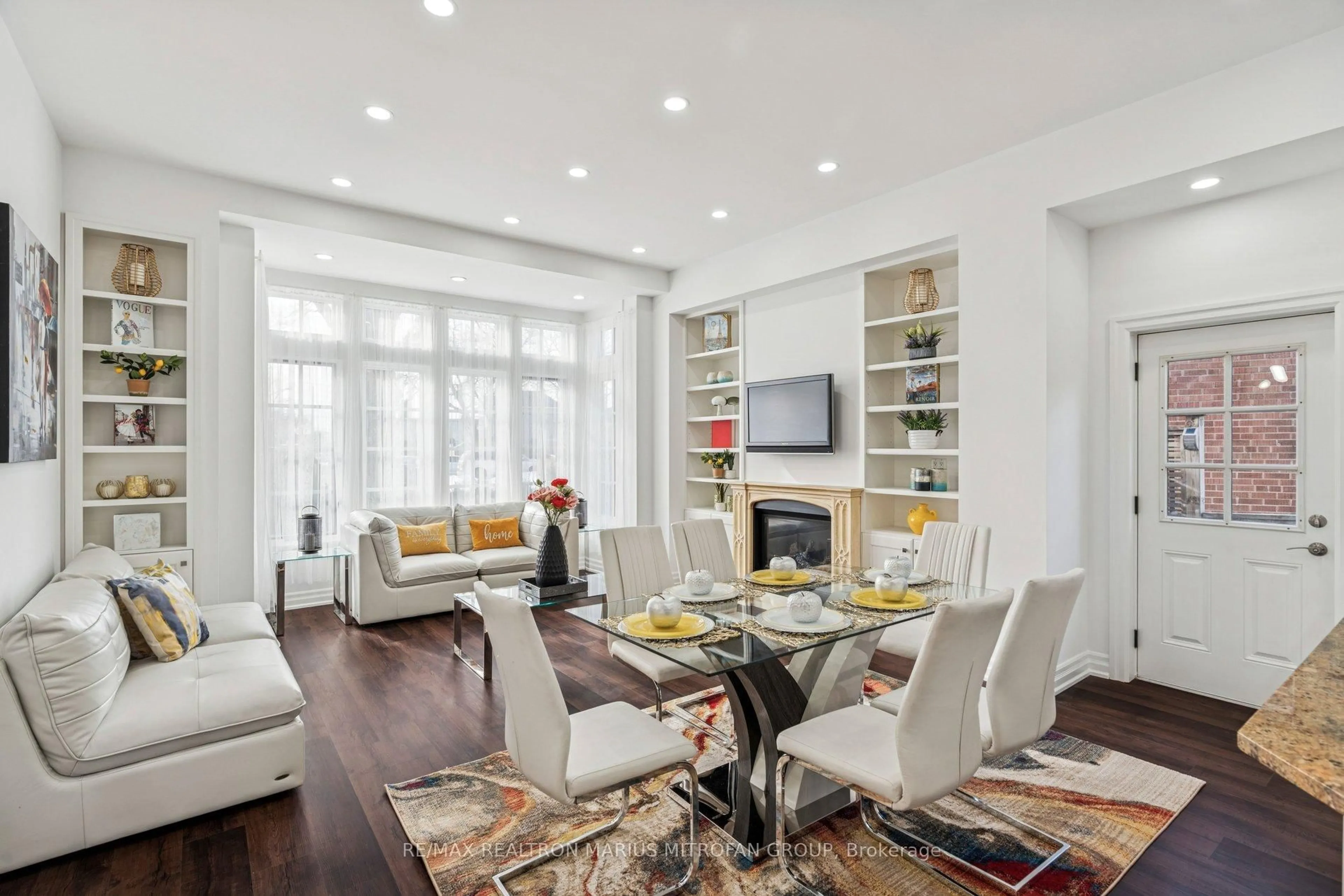 Living room with furniture, wood/laminate floor for 7 Rollins Pl, Toronto Ontario M9B 3Y4