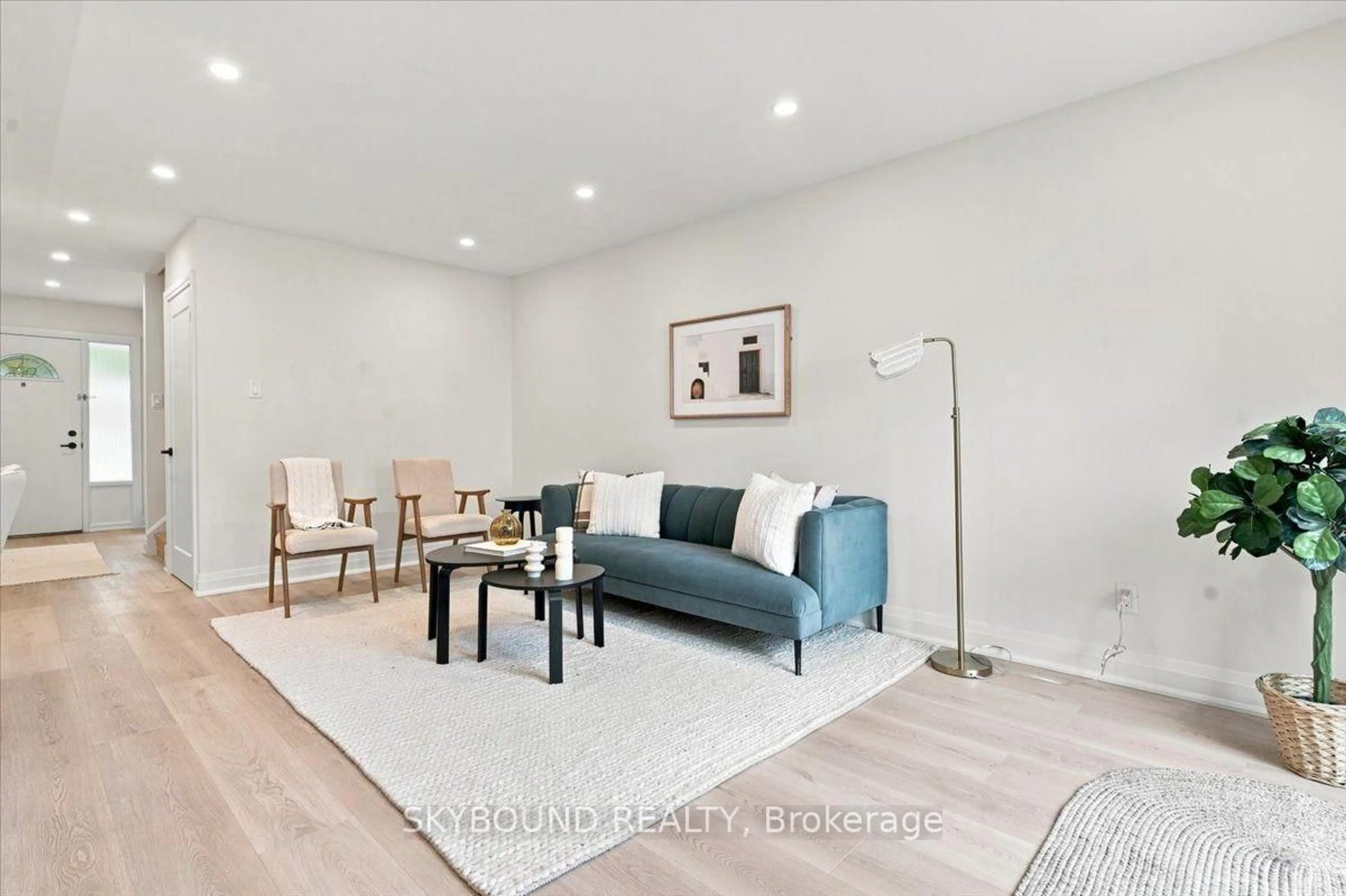 Living room with furniture, wood/laminate floor for 5057 Pinedale Ave #94, Burlington Ontario L7L 5J6