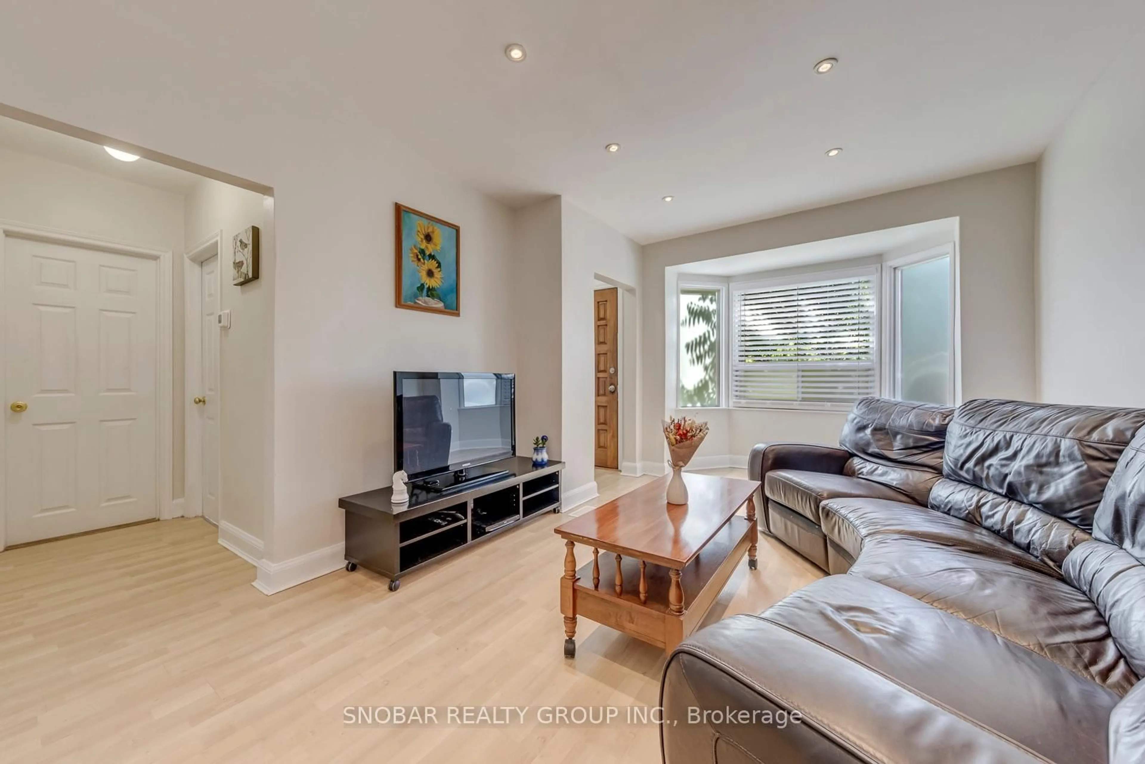 Living room with furniture, wood/laminate floor for 40 Dixon Rd, Toronto Ontario M9P 2L3