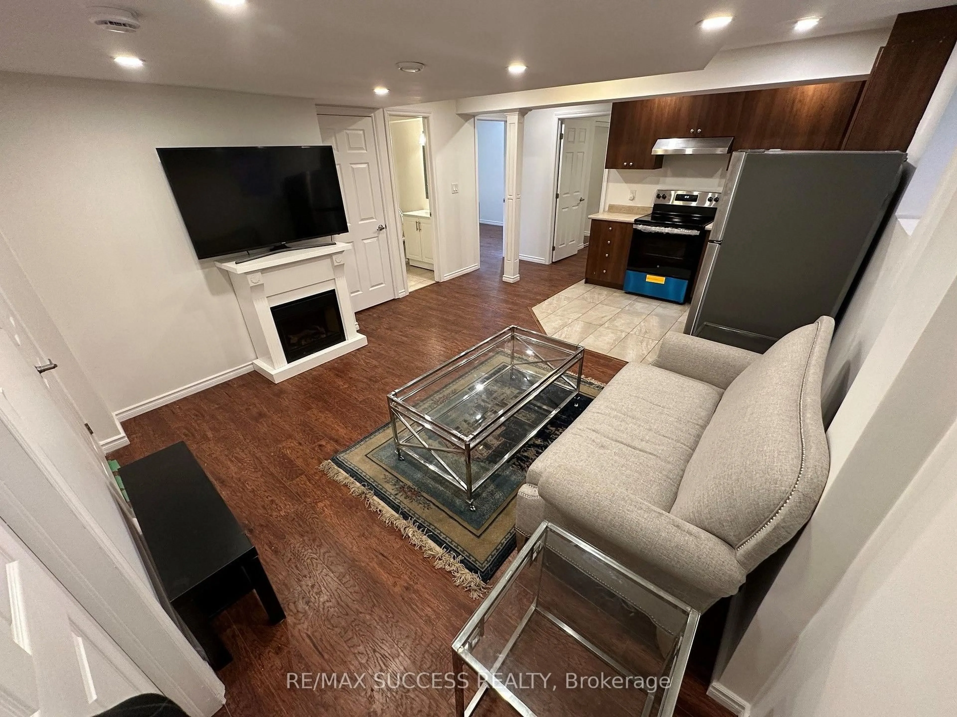 Living room with furniture, wood/laminate floor for 916 Minchin Way #Basement, Milton Ontario L9T 7T6