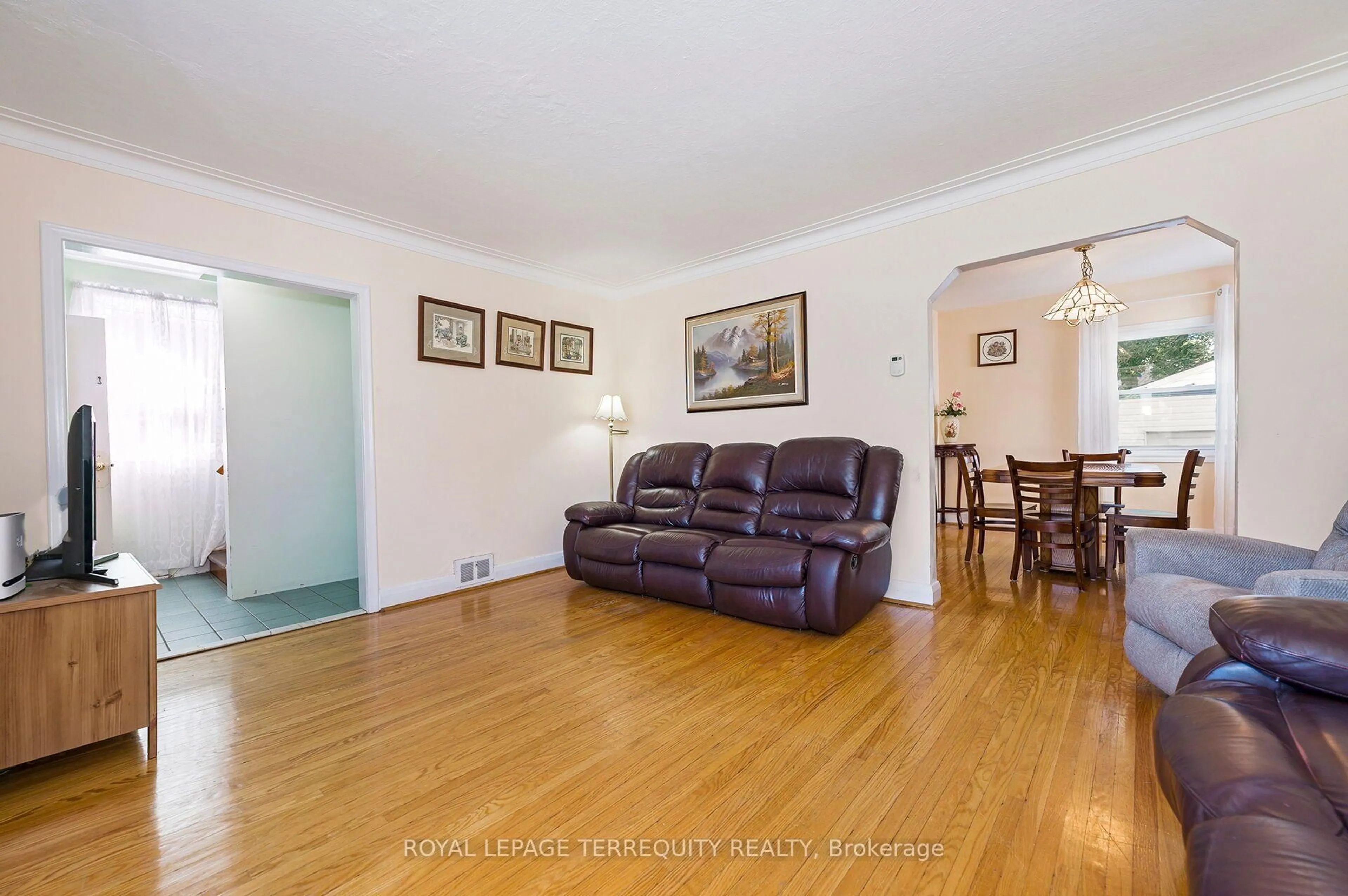 Living room with furniture, wood/laminate floor for 2307 Lawrence Ave, Toronto Ontario M9P 2A7