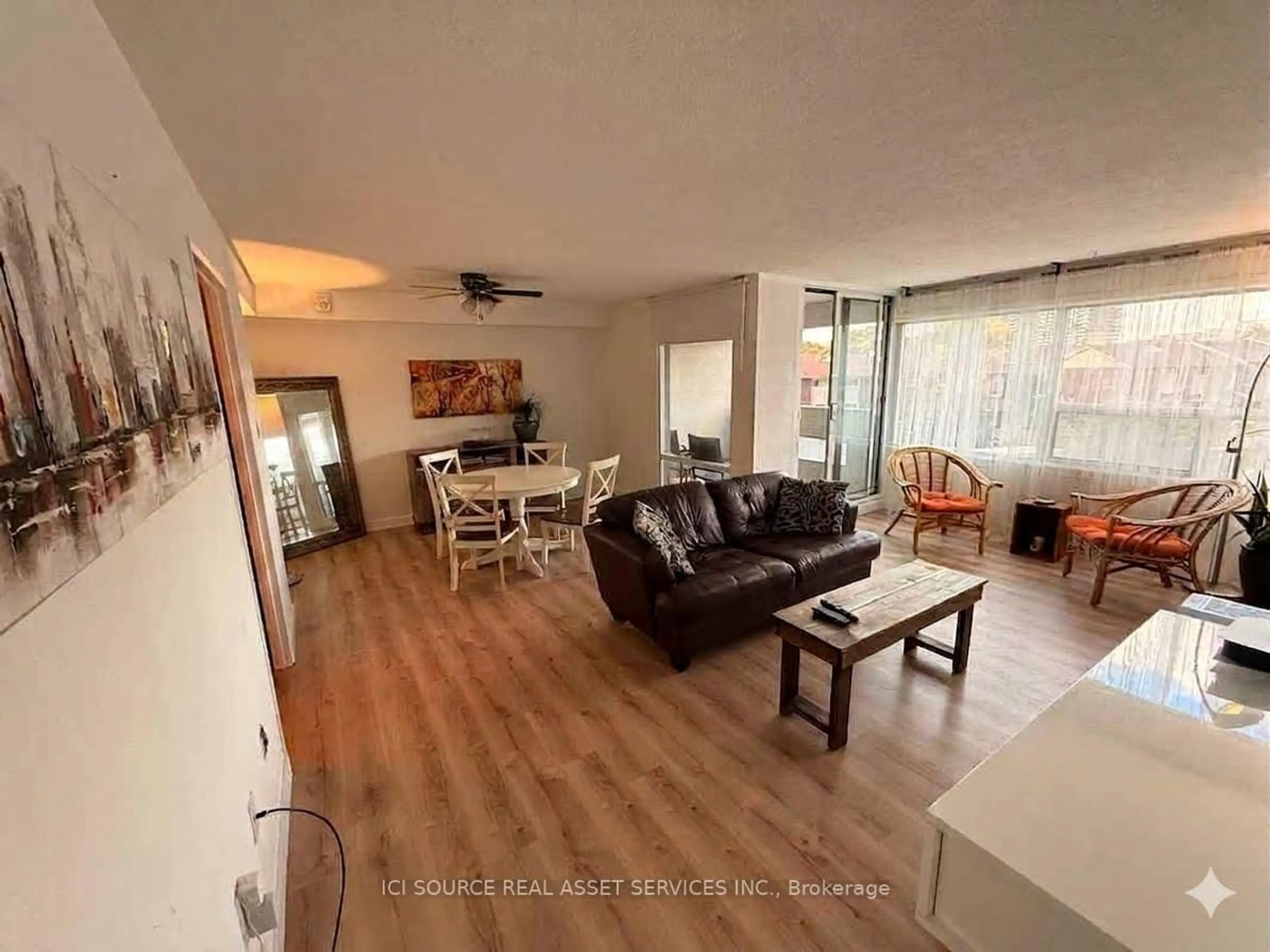 Living room with furniture, wood/laminate floor for 475 The West Mall #310, Toronto Ontario M9C 4Z3