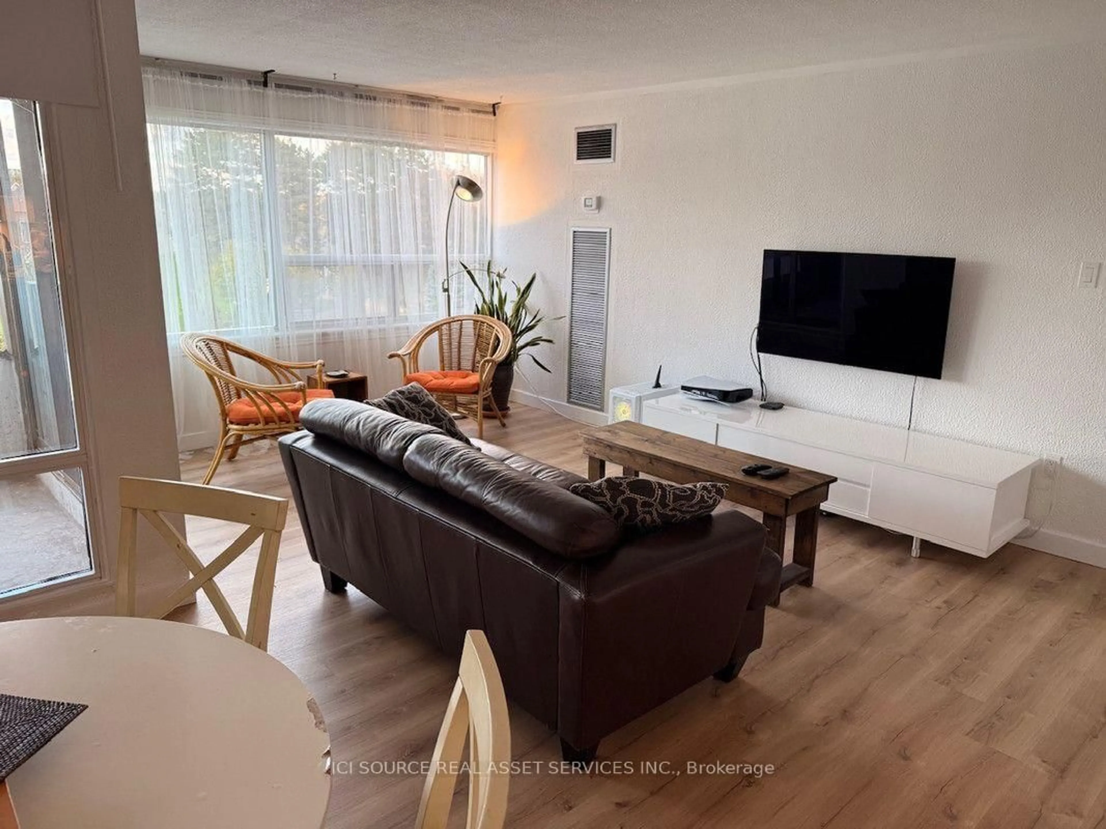 Living room with furniture, wood/laminate floor for 475 The West Mall #310, Toronto Ontario M9C 4Z3