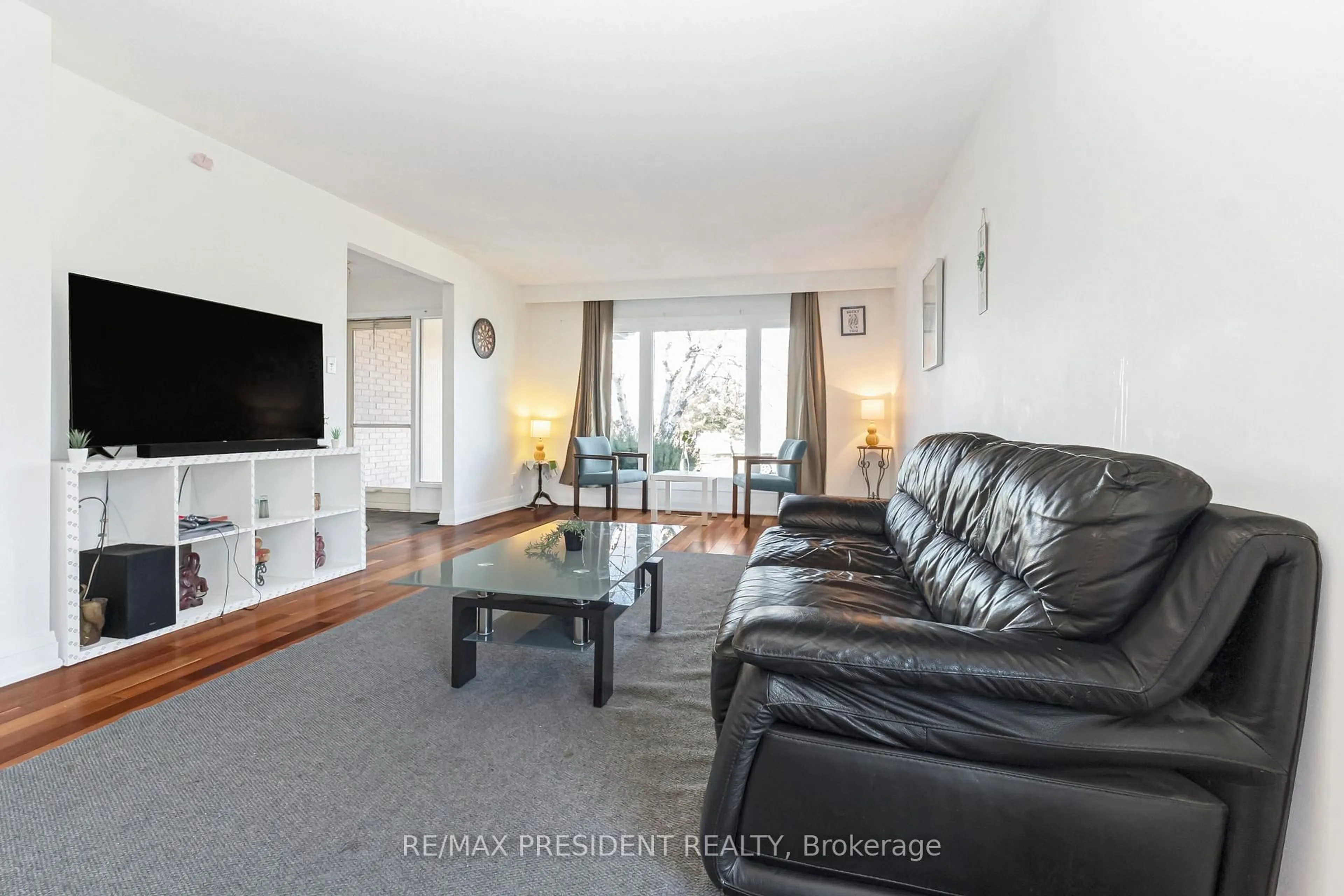 Living room with furniture, wood/laminate floor for 384 Centre St, Brampton Ontario L6V 3L6