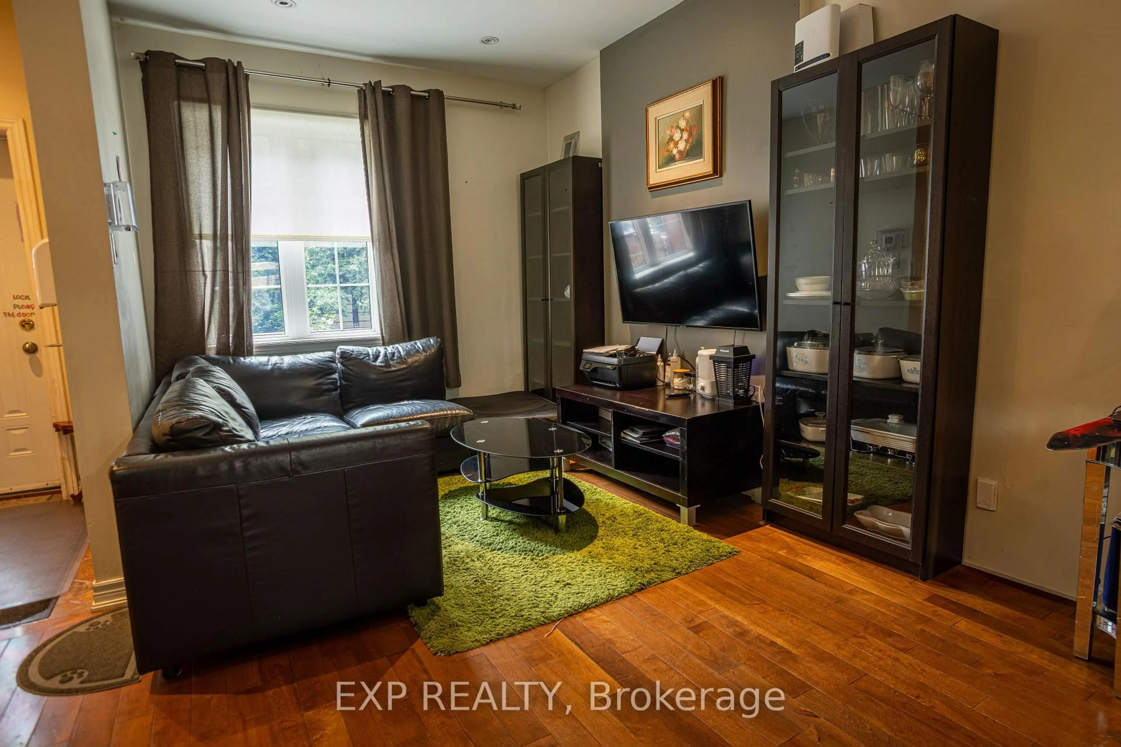 Living room with furniture, wood/laminate floor for 971 Lansdowne Ave, Toronto Ontario M6H 3Z5
