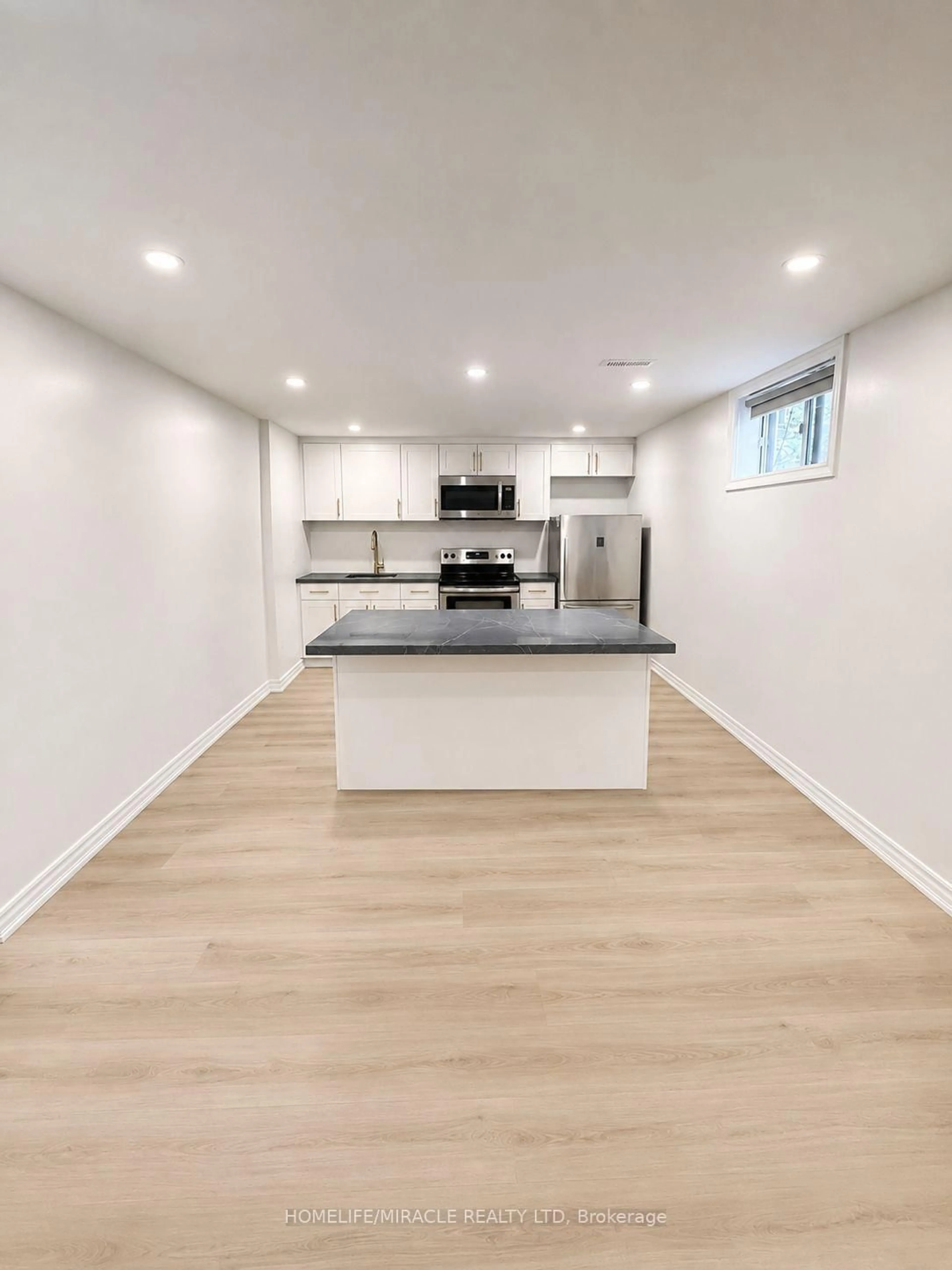 Open concept kitchen, wood/laminate floor for 23 Brussels St, Toronto Ontario M8Y 1H2
