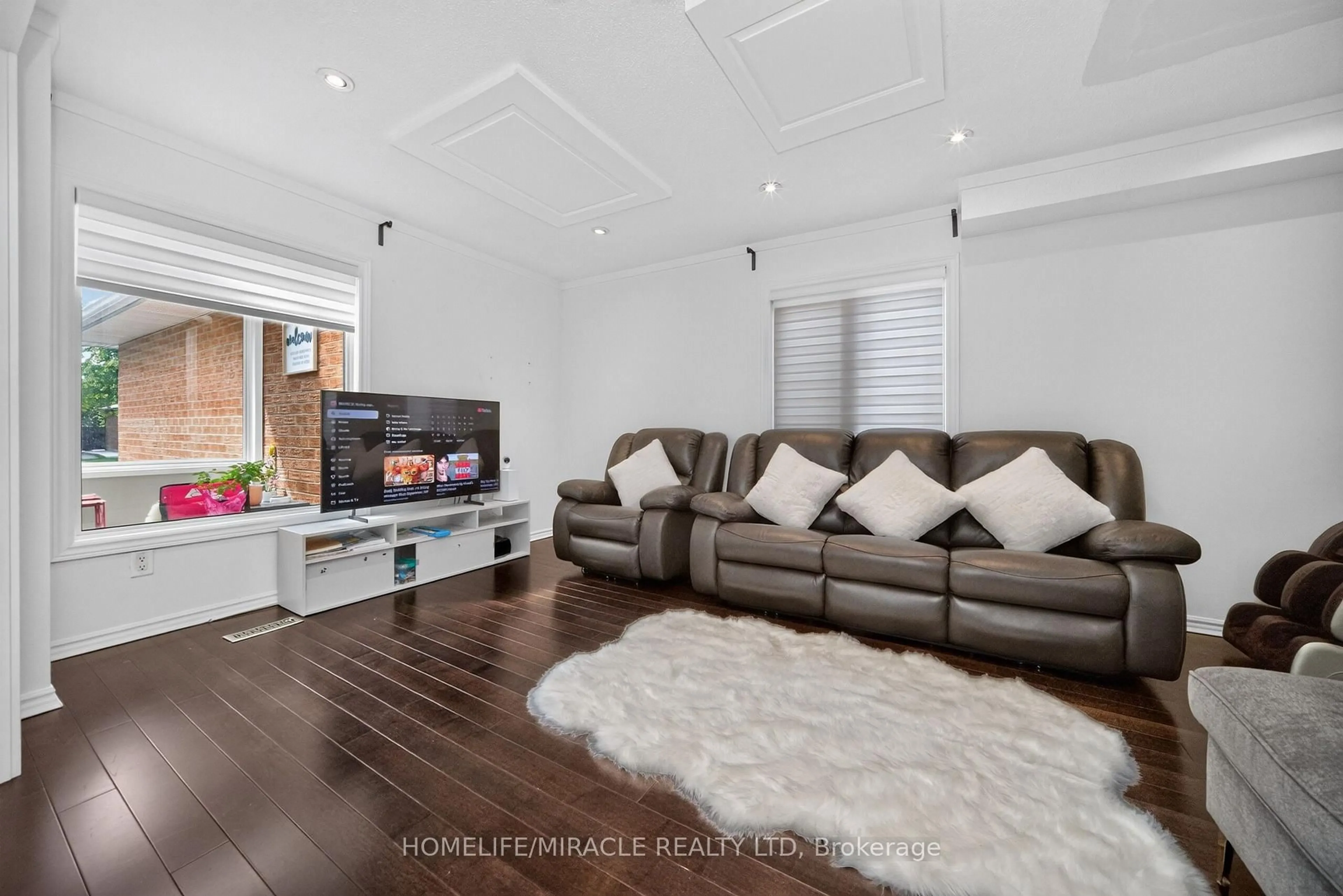 Living room with furniture, wood/laminate floor for 4 Summertime Crt, Brampton Ontario L6Z 2B4