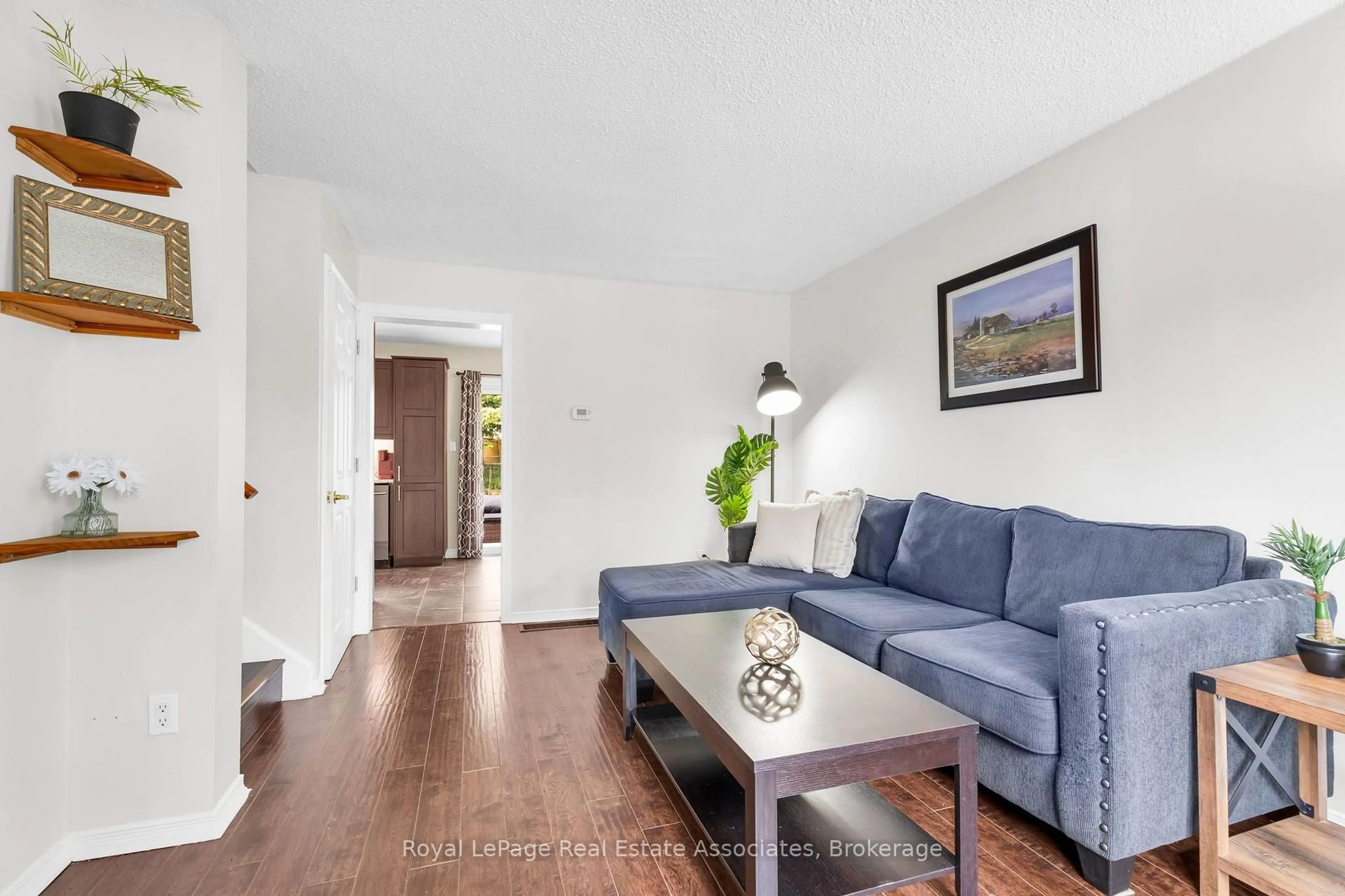 Living room with furniture, wood/laminate floor for 81 Glenmore Cres, Brampton Ontario L6S 1H9