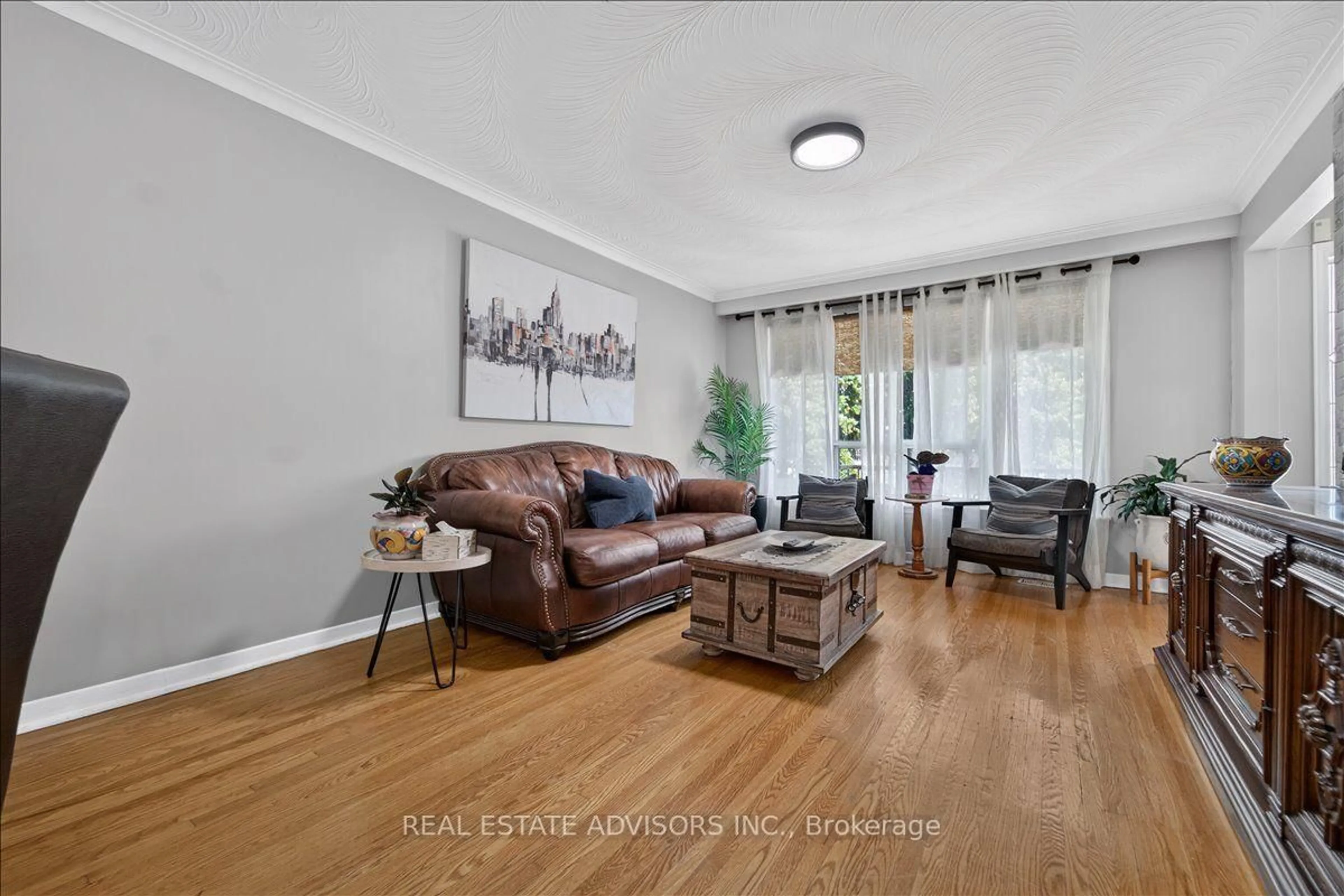 Living room with furniture, wood/laminate floor for 14 Grampian Cres, Toronto Ontario M9L 2L3