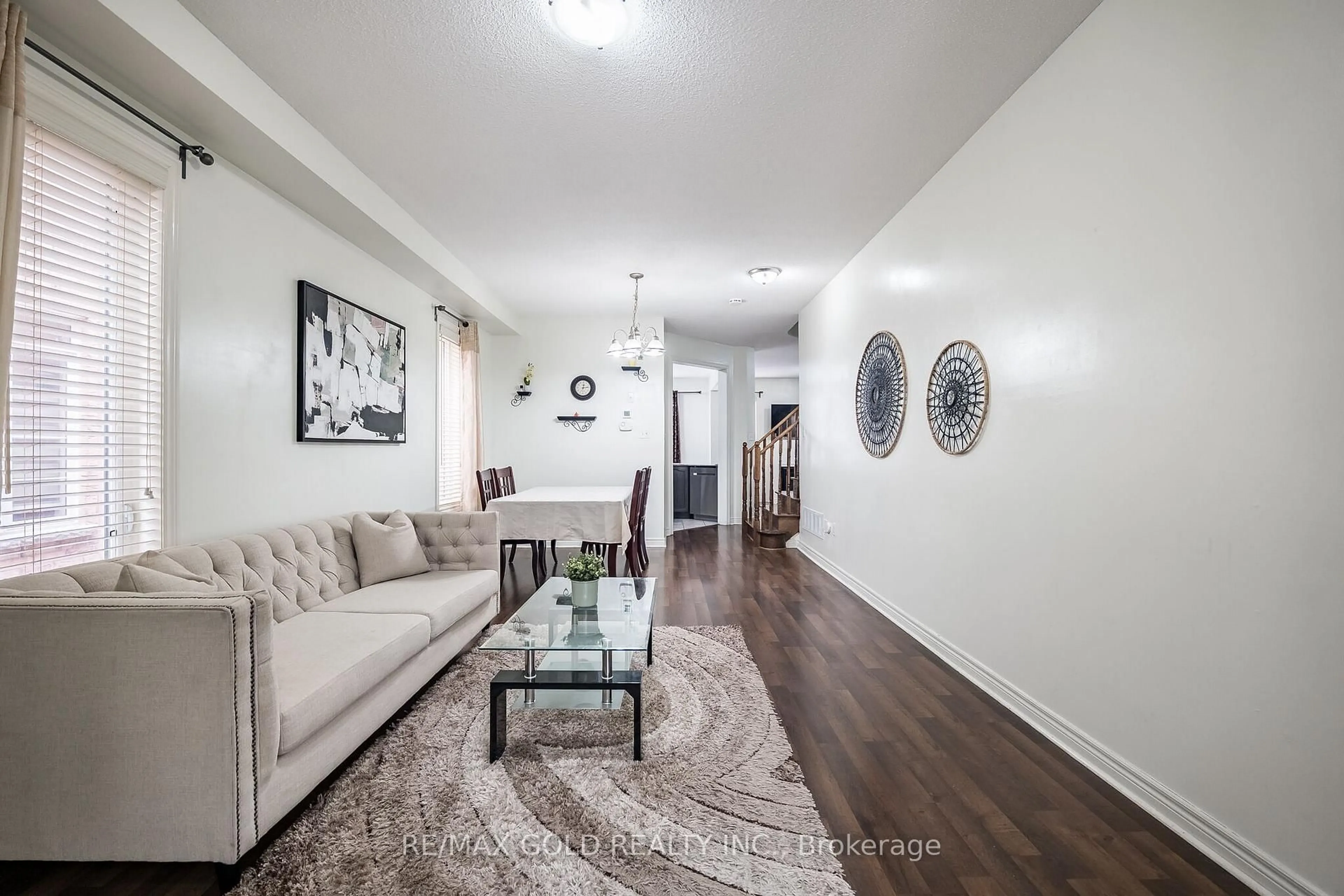 Living room with furniture, wood/laminate floor for 49 Baby Pointe Tr, Brampton Ontario L7A 0W3