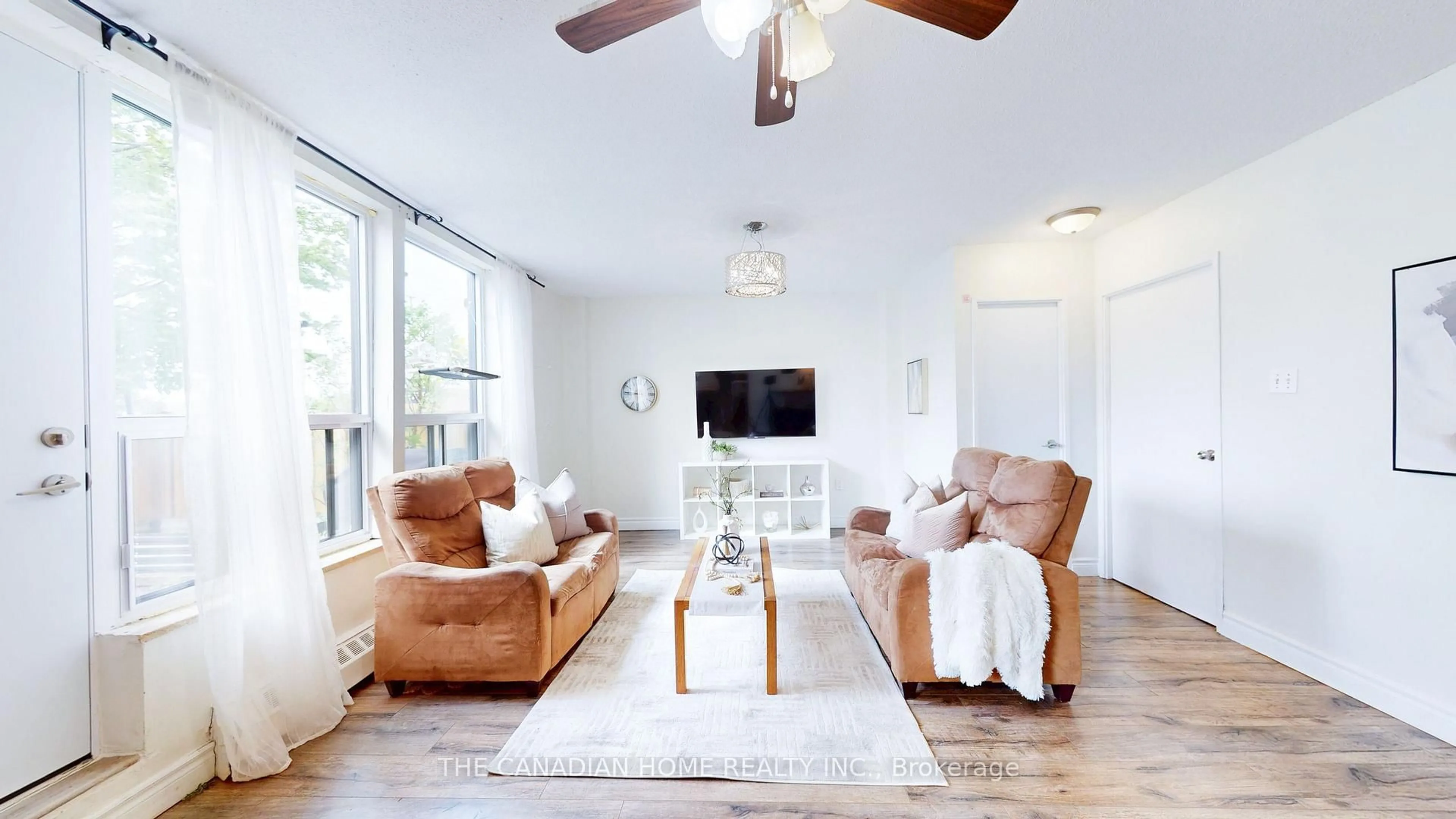 Living room with furniture, wood/laminate floor for 1055 A Forestwood Dr #115, Mississauga Ontario L5C 2T8