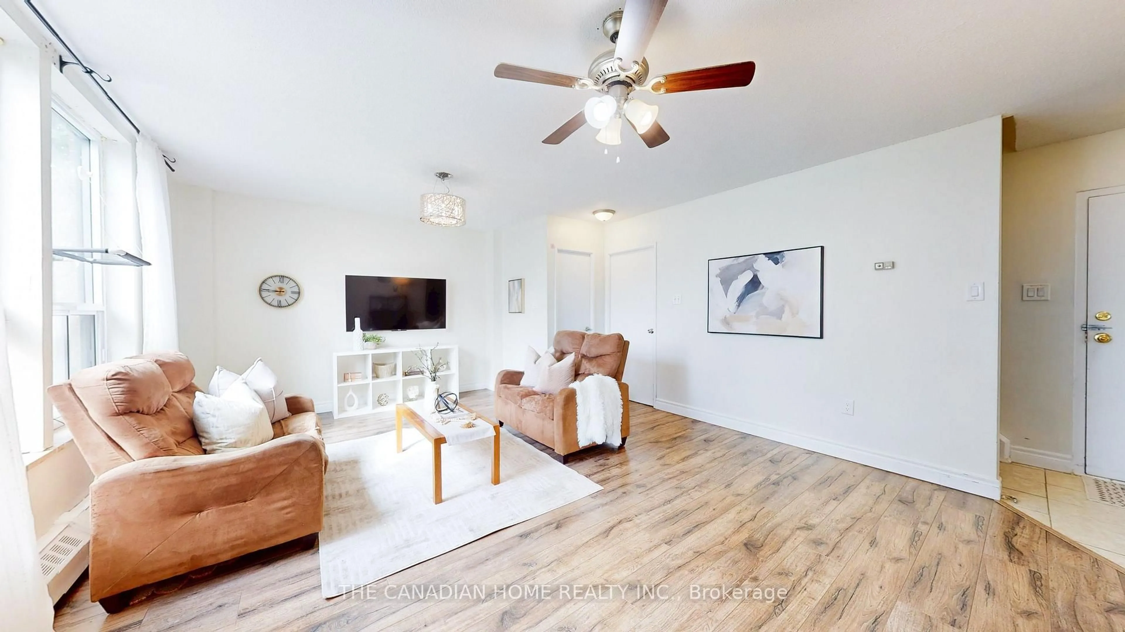 Living room with furniture, wood/laminate floor for 1055 A Forestwood Dr #115, Mississauga Ontario L5C 2T8