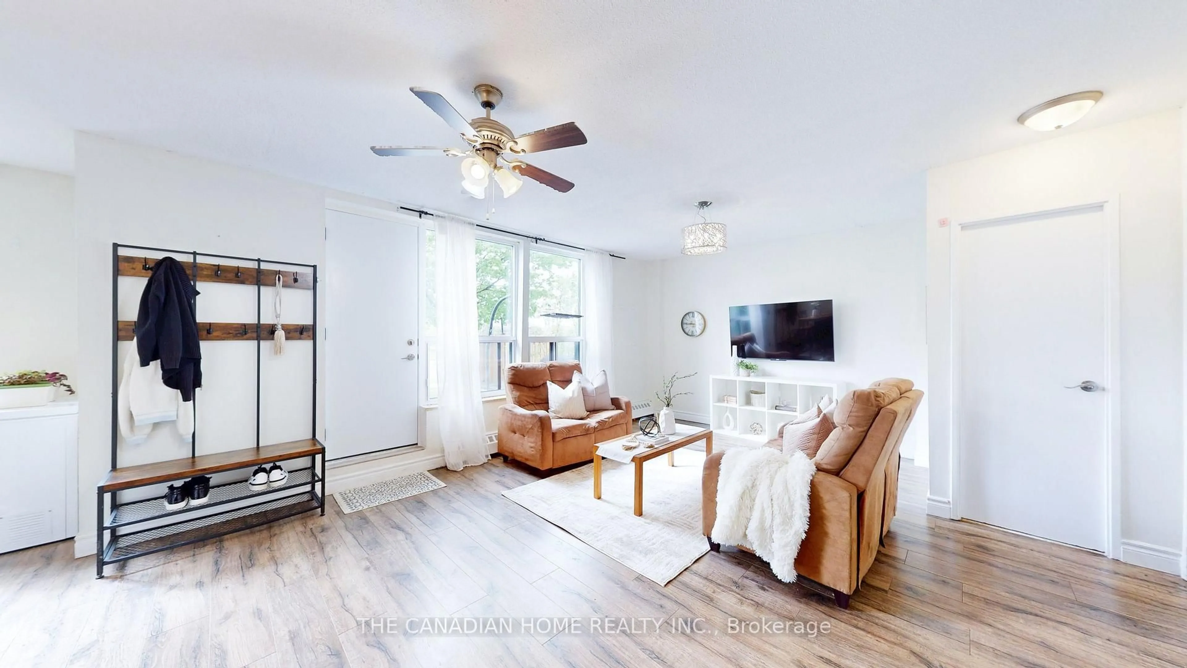Living room with furniture, wood/laminate floor for 1055 A Forestwood Dr #115, Mississauga Ontario L5C 2T8