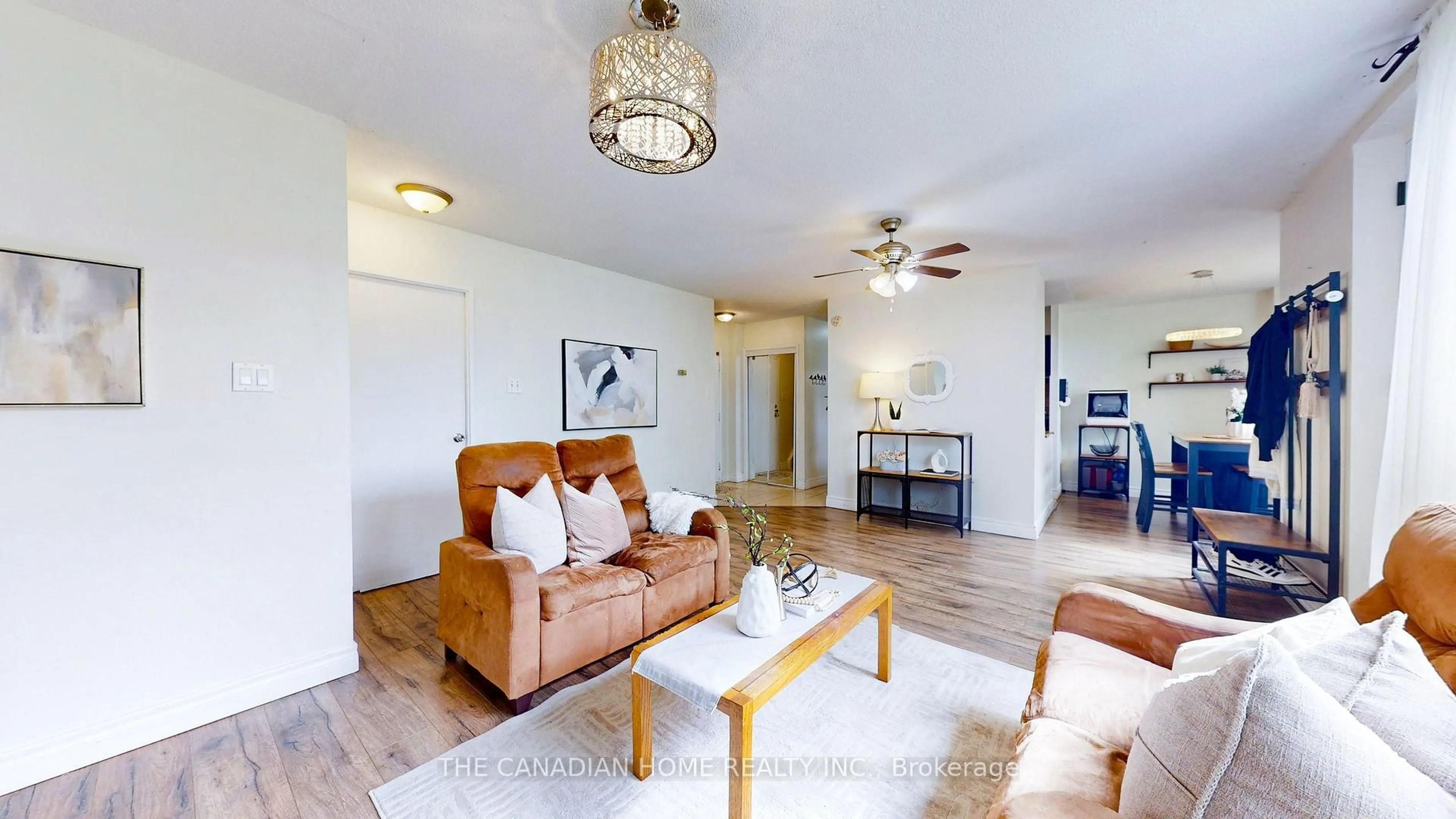 Living room with furniture, wood/laminate floor for 1055 A Forestwood Dr #115, Mississauga Ontario L5C 2T8
