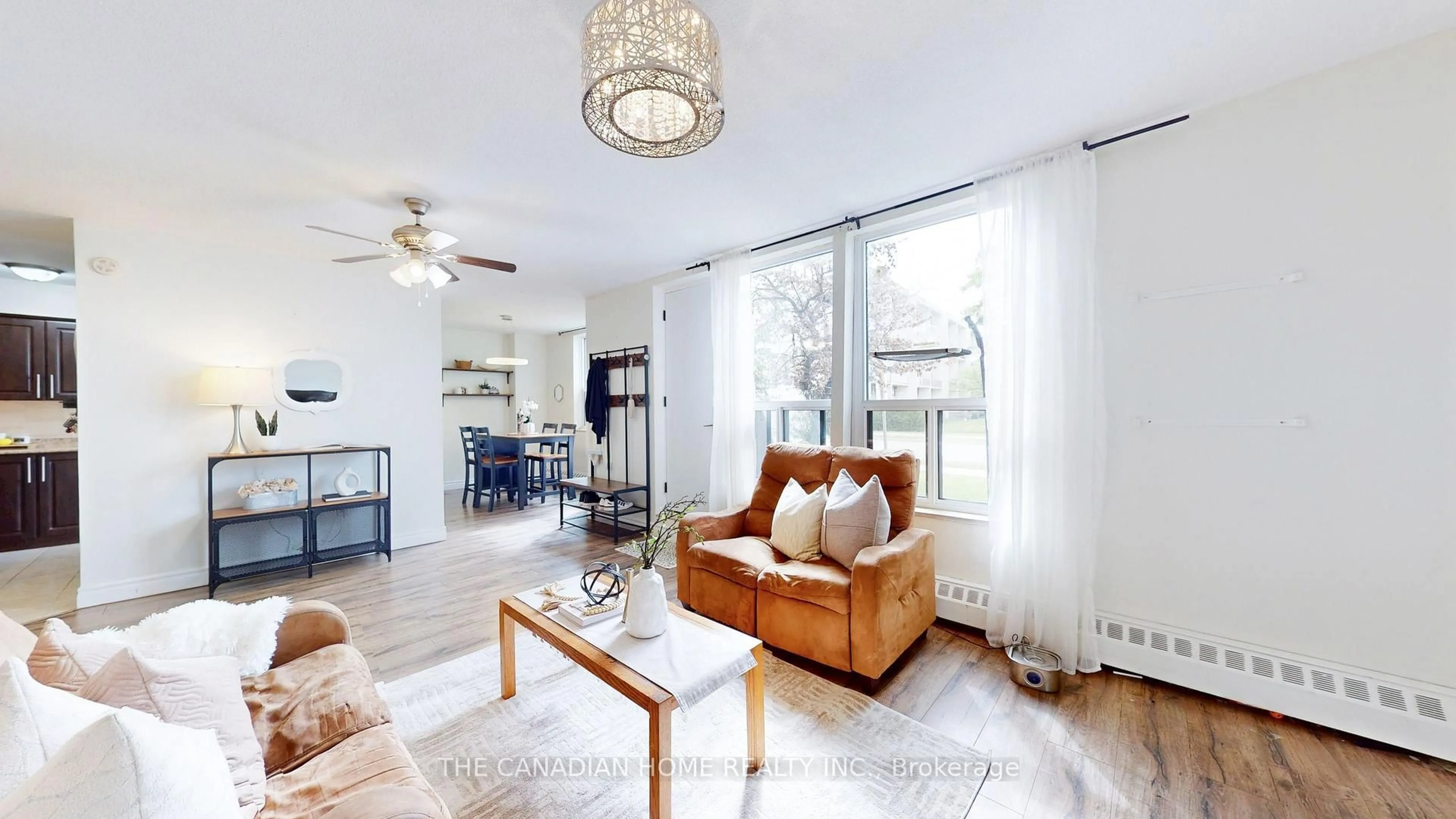 Living room with furniture, wood/laminate floor for 1055 A Forestwood Dr #115, Mississauga Ontario L5C 2T8