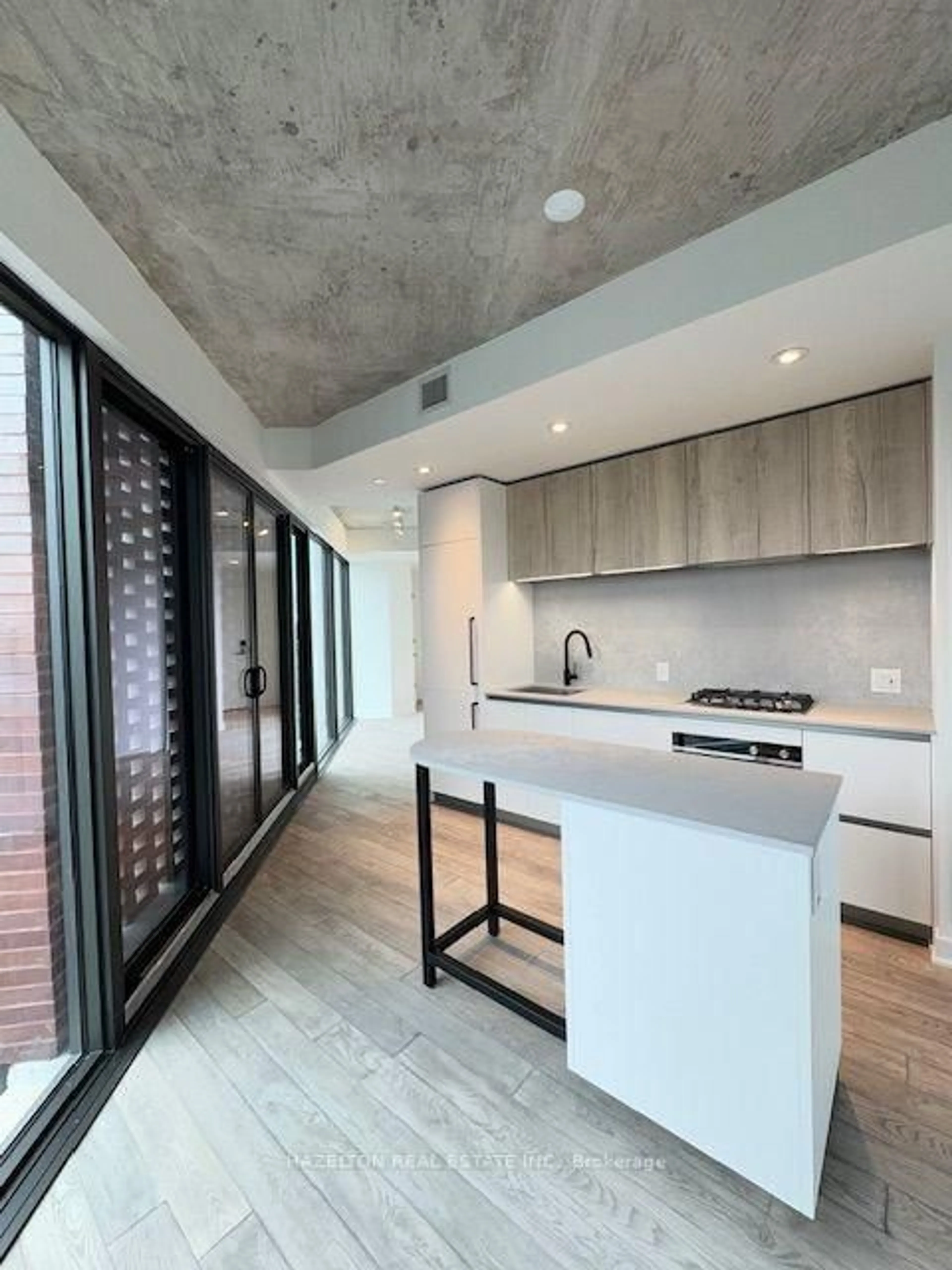 Open concept kitchen, cement floor for 2625 Dundas St #514, Toronto Ontario M6P 0C5